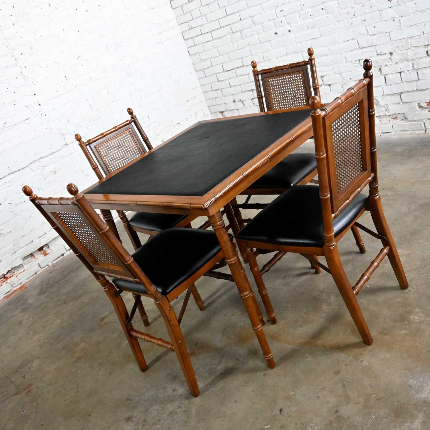 Wonderful vintage Campaign style faux bamboo folding table and 4 folding chairs with faux leather seat cushions and tabletop by Stakmore Furniture. Beautiful condition, keeping in mind that this set is vintage and not new so will have signs of use
