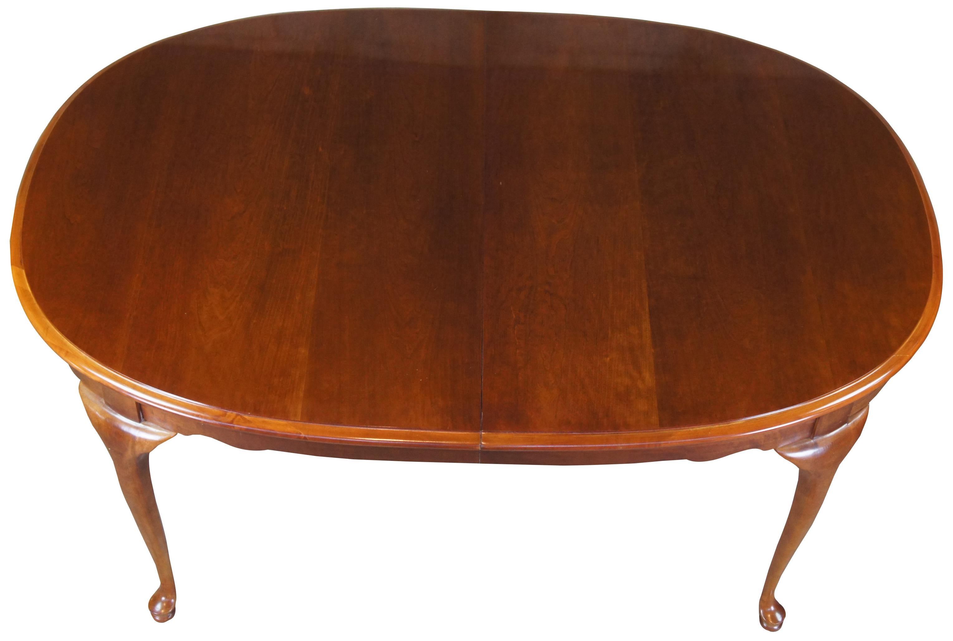 Vintage Stanley Furniture dining table. Made of solid cherry featuring an oval shape with two leaves and slipper feet. Measure: 98