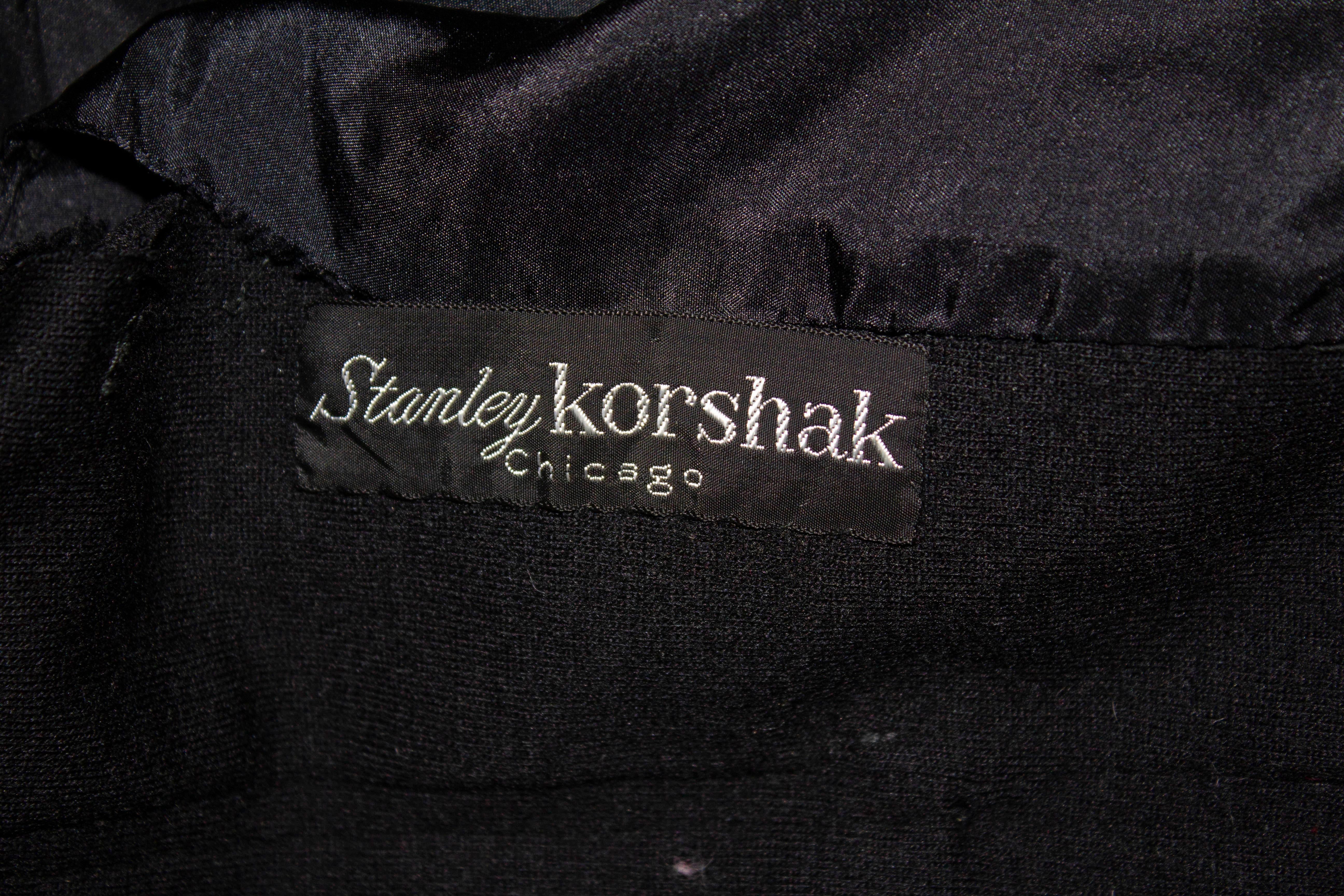 A chic vintage cocktail dress by Stanley Korshak. The dress is in a black jersey with bow detail on the front. It has a front zip opening,  gathering at the waist and is fully lined. 
Measurements: Bust 36 '', waist 28'',length 43'' plus a 4'' hem.