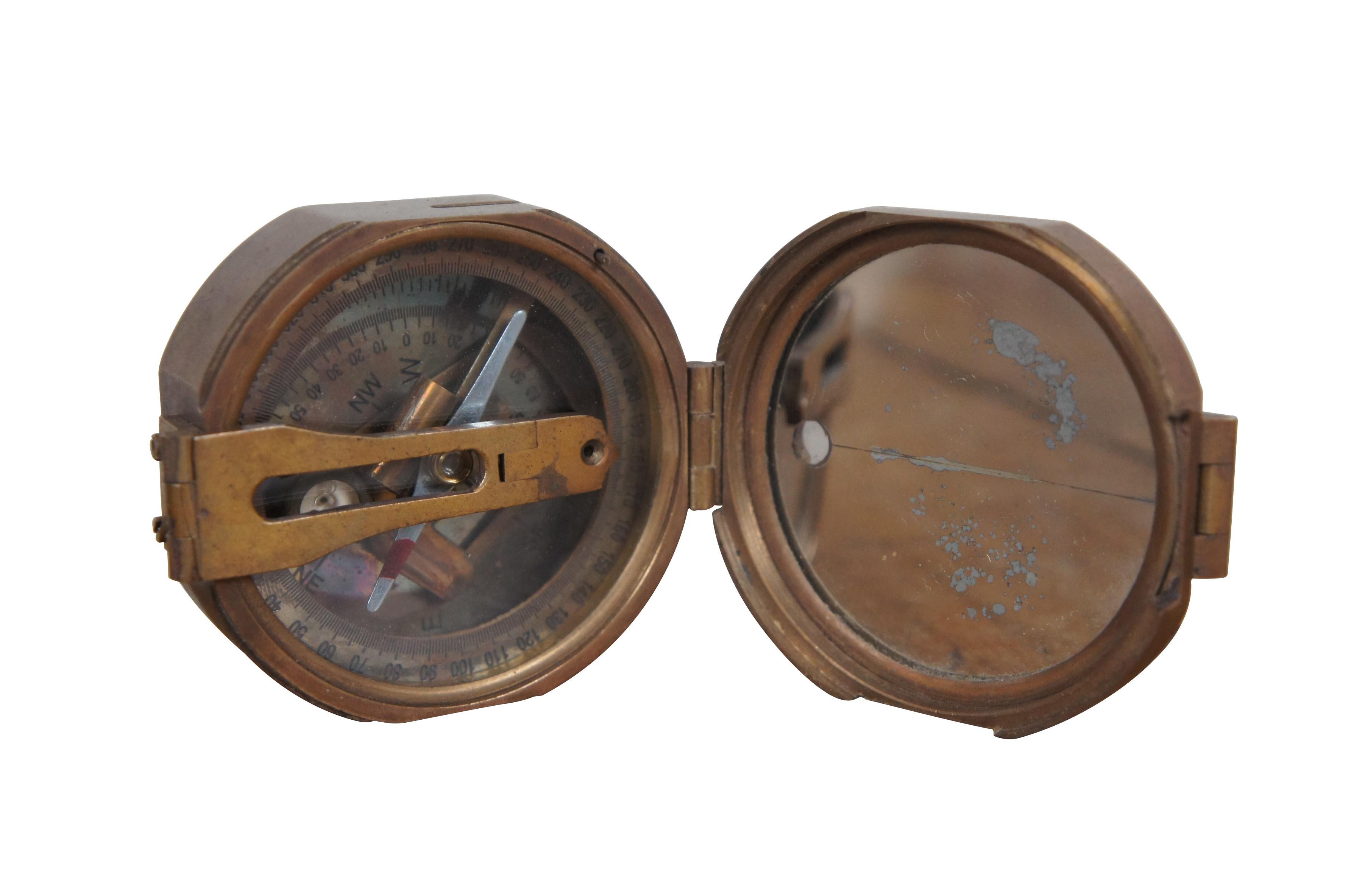 Vintage Stanley London brass Brunton style navigational compass. Natural Sine chart on lid. Mirrored interior of lid with folding sight. Etched brass face with circular and tube bubble levels.

