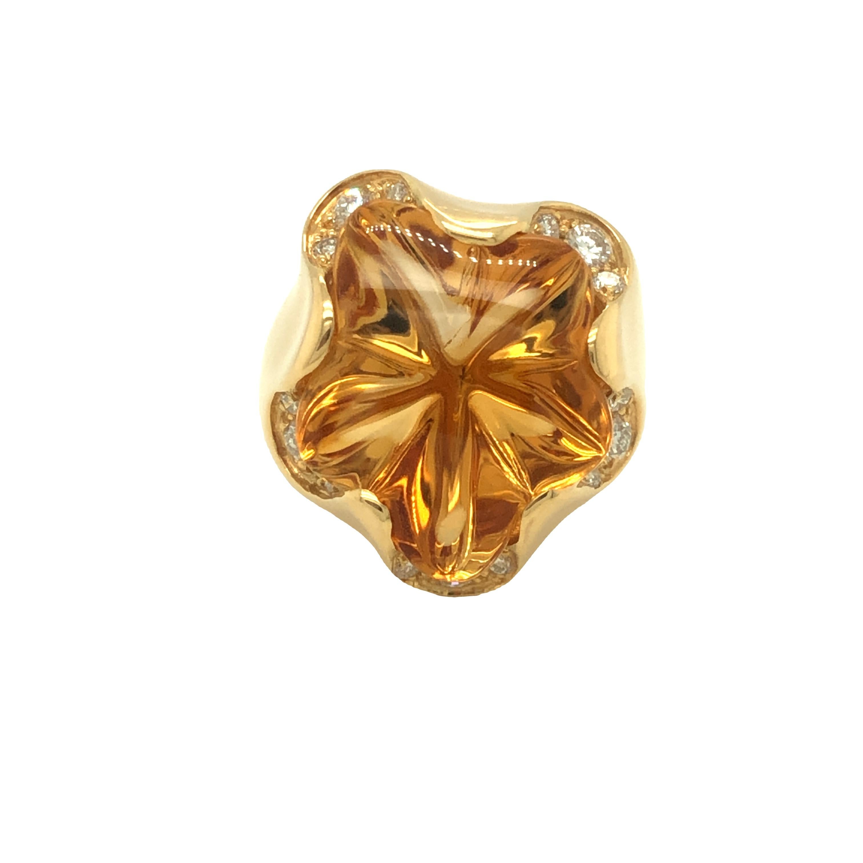 From our estate collection,  this artfully carved free-formed star shaped Citrine is beautifully set in handcrafted 18k yellow gold with colorless round brilliant diamonds on each points. The citrine has vivid golden yellow color. The ring is in