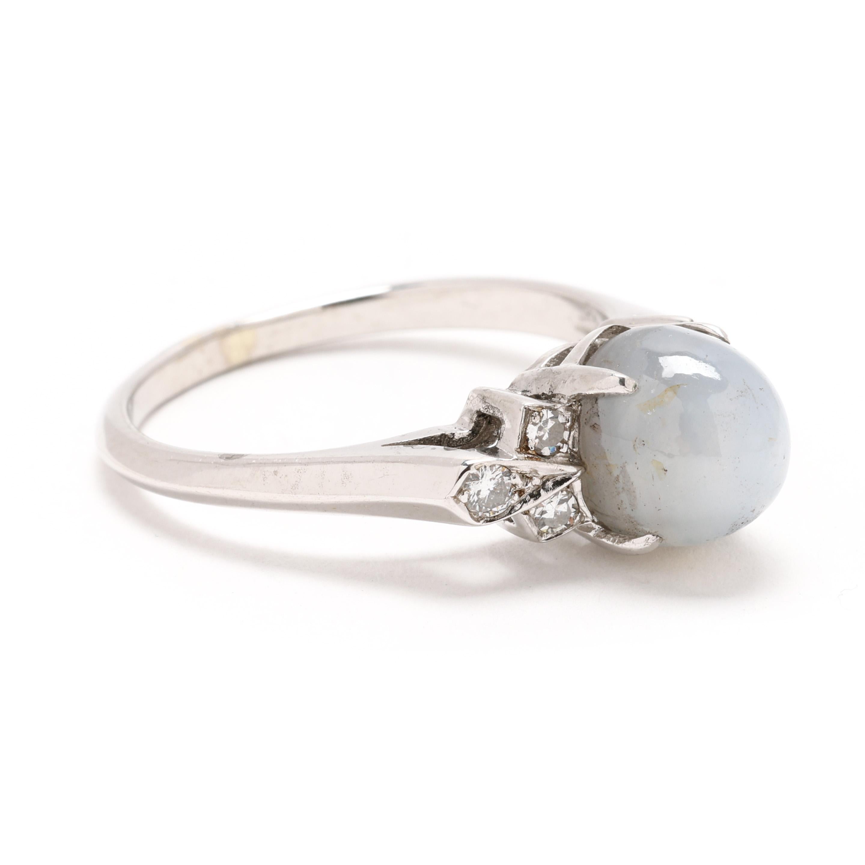 Discover the allure of vintage elegance with this stunning star sapphire and diamond ring, set in gleaming 14k white gold. The captivating star sapphire radiates a unique natural star pattern, while sparkling diamonds accentuate its beauty, creating