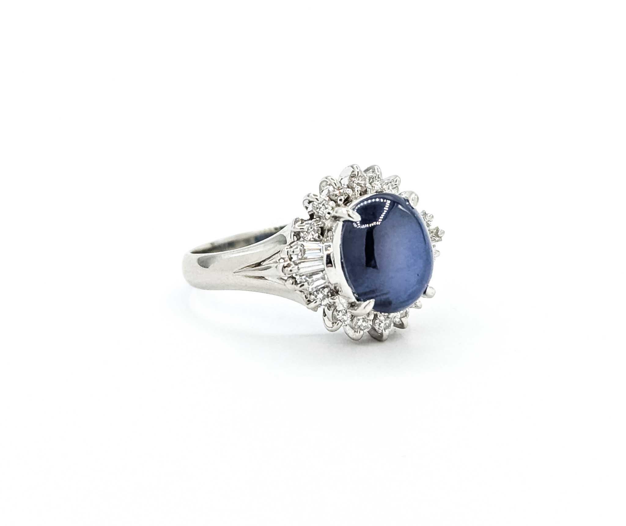 This extraordinary cocktail ring features a 4.47 carat oval star sapphire measuring 15 x 14.5mm, set in 900pt platinum mounting. The cabochon sapphire displays a soft blue hue with the desirable star effect, enhanced by a sparkling halo of round and
