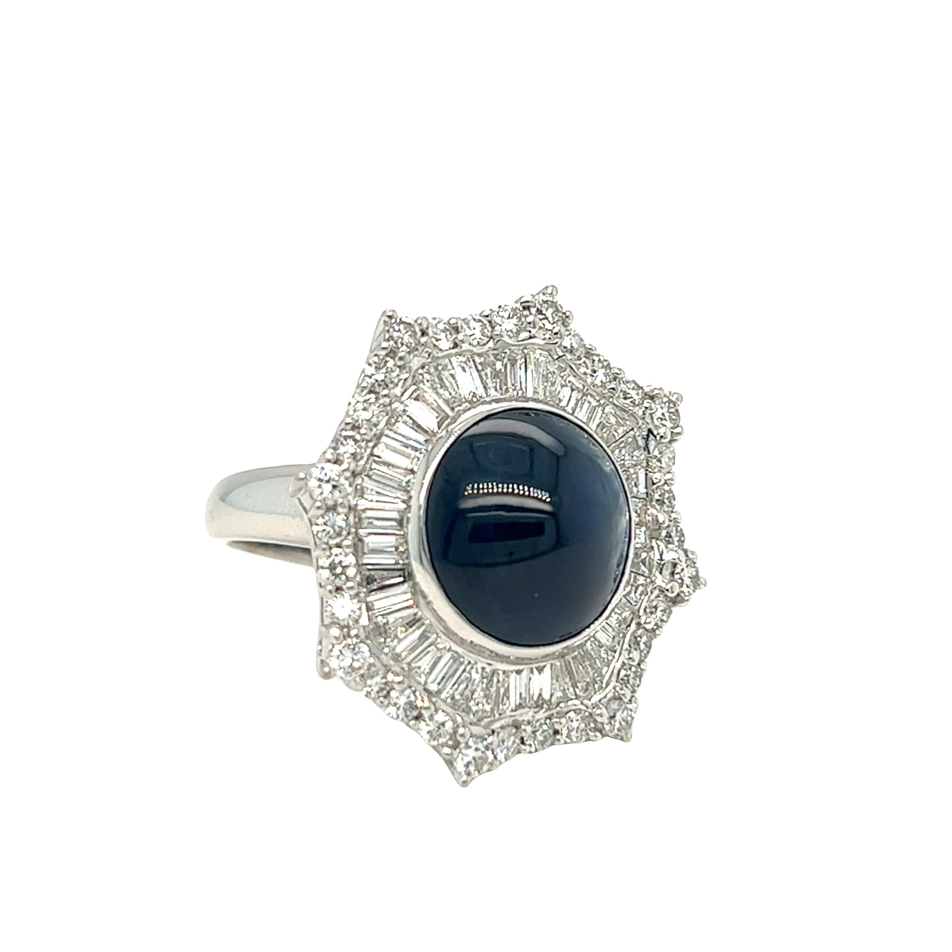This stunning piece of jewelry is made of 18K white gold and features a starburst design. The ring has a classic style and is highlighted by a high-domed cabochon sapphire that weighs 8 carats. The sapphire is surrounded by a halo of round