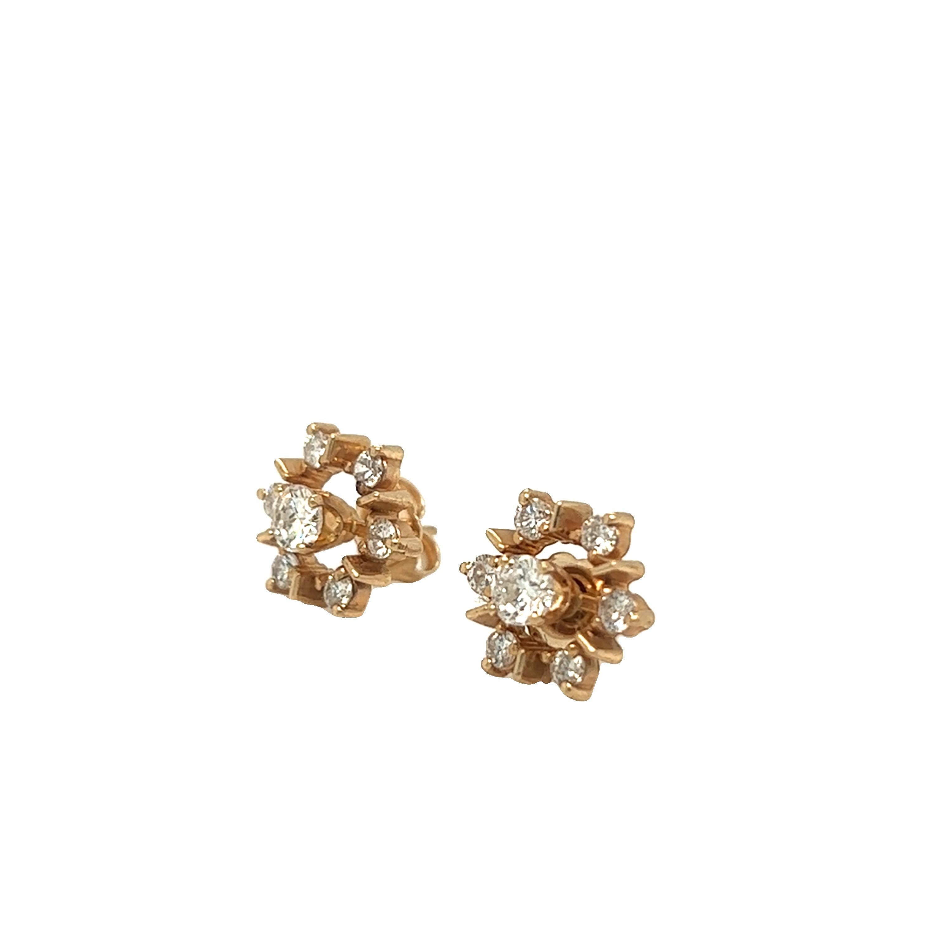 These vintage dainty flower earrings each features a center stone diamond weighing approximately 0.20 carat. Each center stone is gracefully surrounded by six small round cut diamonds weighing about 0.20 carats. The total weight of diamonds is