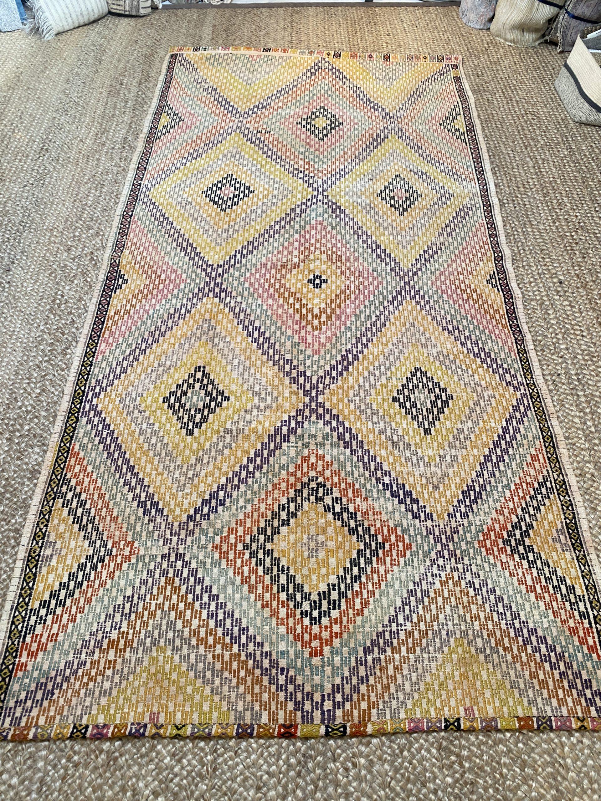 Origin: Turkey
Dimensions: 10’2? x 5'
Age: 1950’s
Design: Jajim
Material: 100% Wool Flatweave
Color: Yellow, Purple, Pink, Orange, Mint

 K6757

Jajim is a thin, handmade carpet full of pattern and woven horizontally. The name is derived