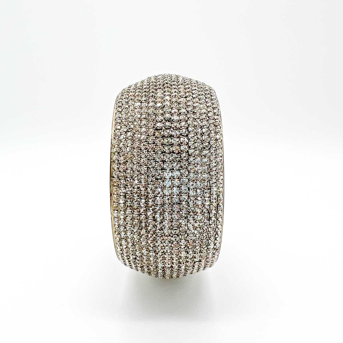 A stunning Vintage Diamante Bangle oozing wall to wall sparkly crystals. Worn alone or stacked this incredible piece will add glam on every outing.
Vintage Condition: Very good without damage or noteworthy wear. The silver plating inside the bangle