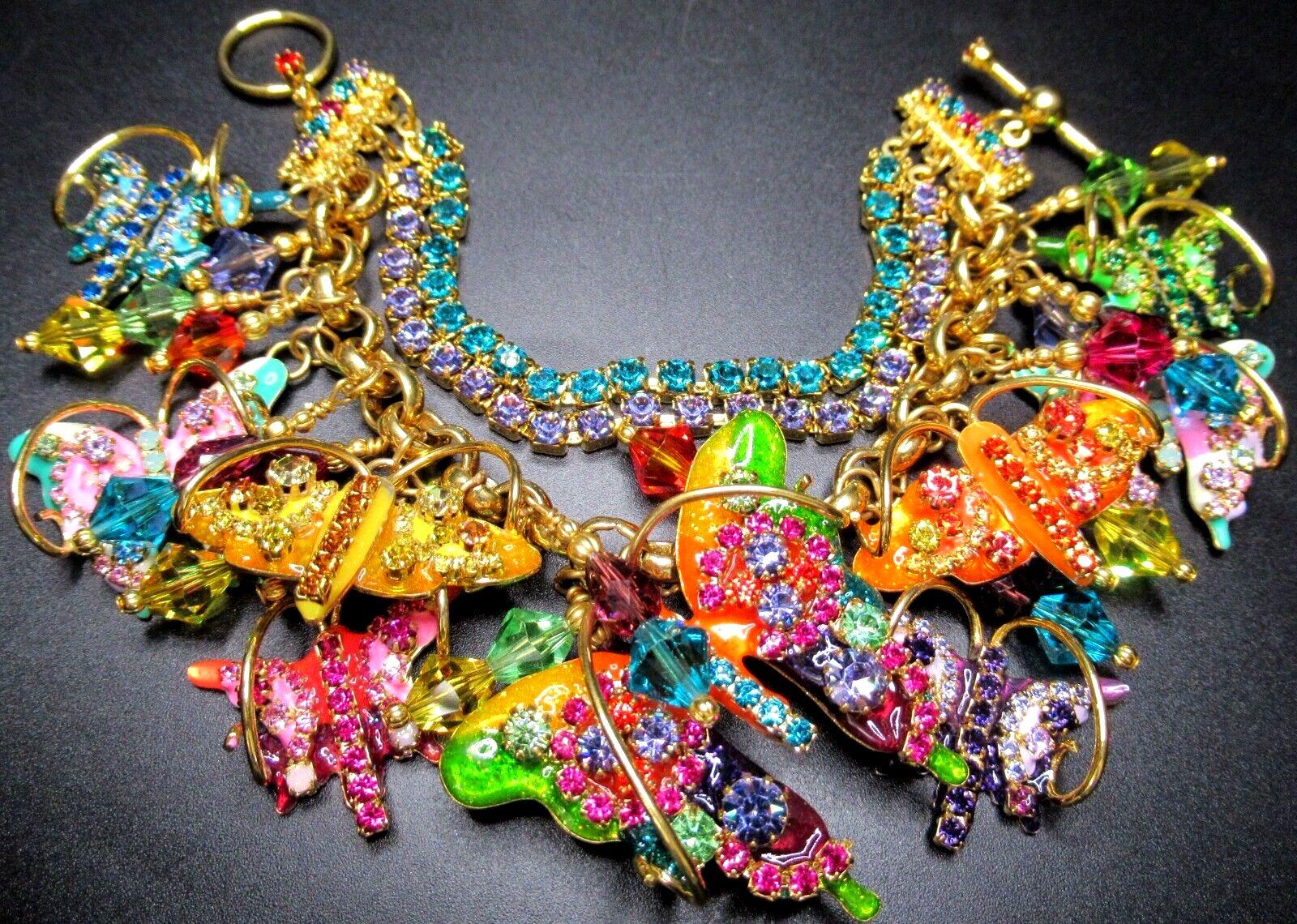 Simply Beautiful! Oscar worthy Iconic LUNCH AT THE RITZ Signed Designer Sparkling Crystal and Enamel Metamorphosis Butterflies Show Stopper Charm Bracelet. Double row Crystal Bracelet, suspending numerous Sparkling Crystal Butterflies. Gold tone