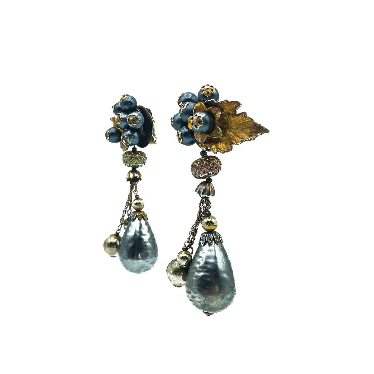 A wonderfully unique pair of vintage statement metallic earrings. Featuring an eye-catching array of metallic tones with floral inspiration. 
Vintage Condition: Very good without damage or noteworthy wear. 
Materials: Lacquered resin beads,