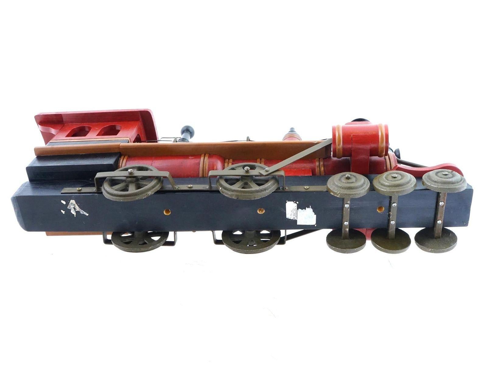 Vintage steam locomotive toy crafted from wood and metal.