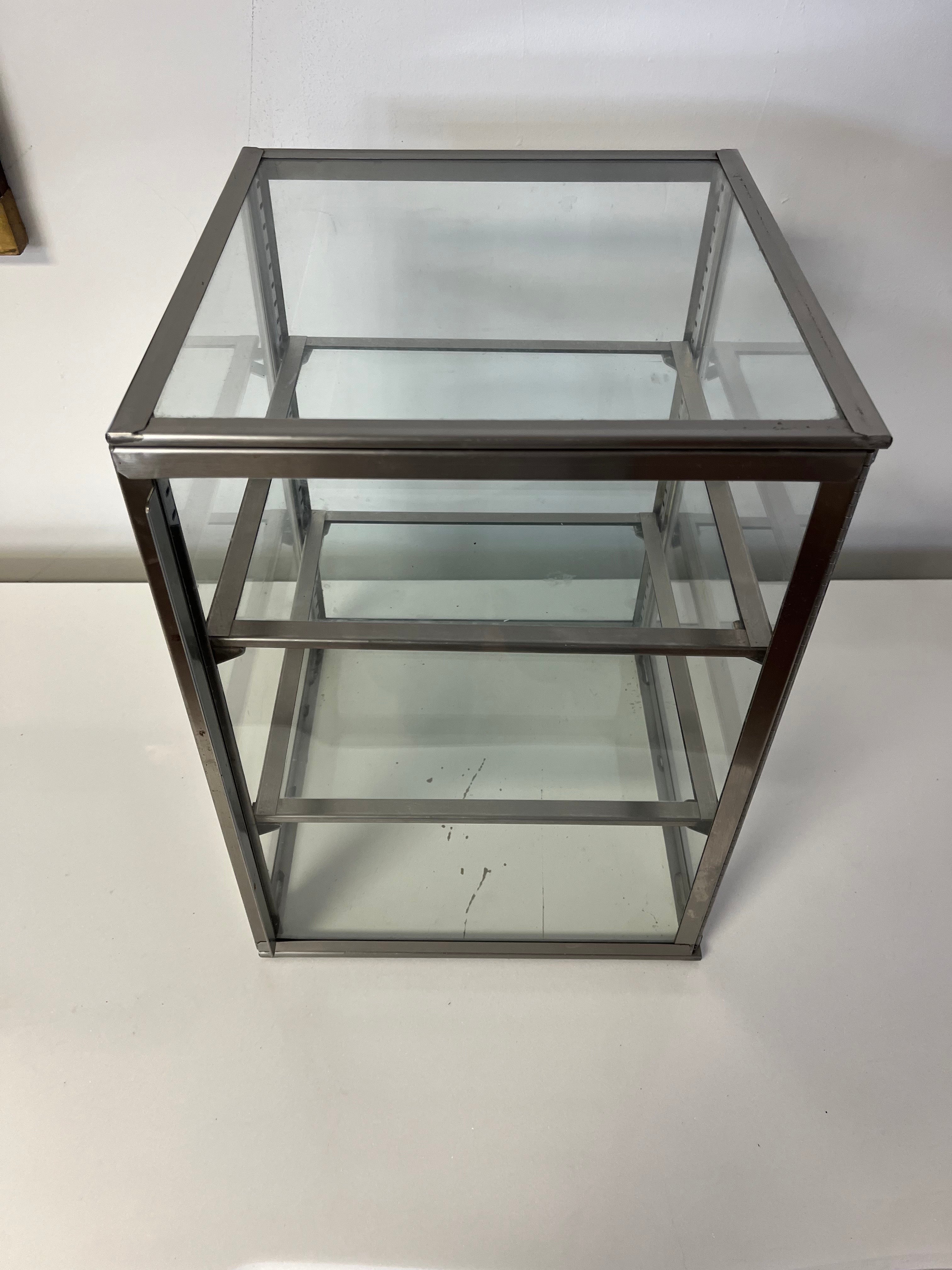 Great simplistic design. Steel and glass medical cabinet with adjustable glass shelves framed in steel. Glass on all sides and top. Front door swings fully open for ease of access. 
