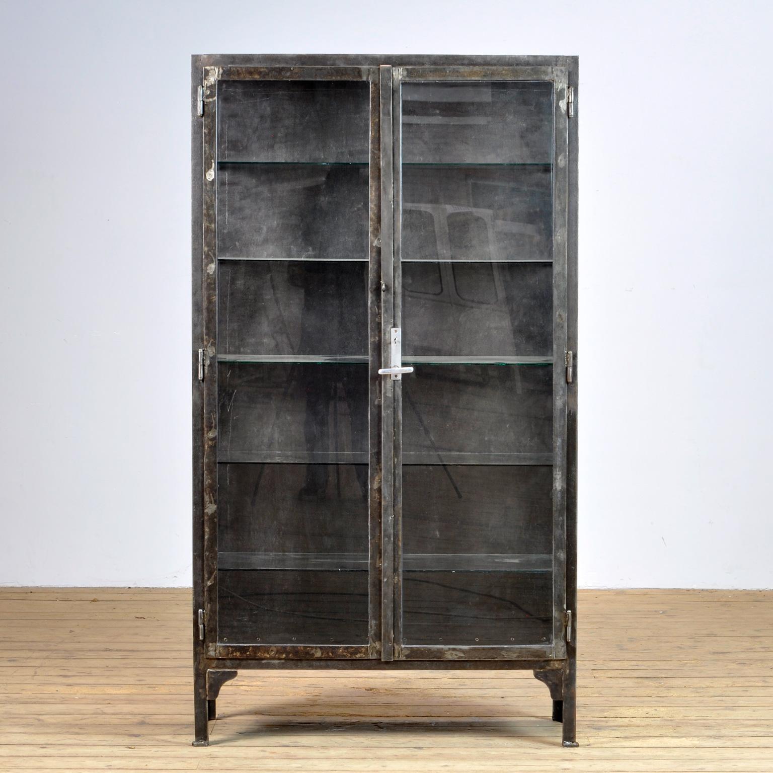 This medical cabinet was produced in the 1930s in Hungary. The cabinet is made from thick iron and glass. The cabinet has been stripped from its paint, polished and treated for rust. It features five glass shelves. Heavy quality.