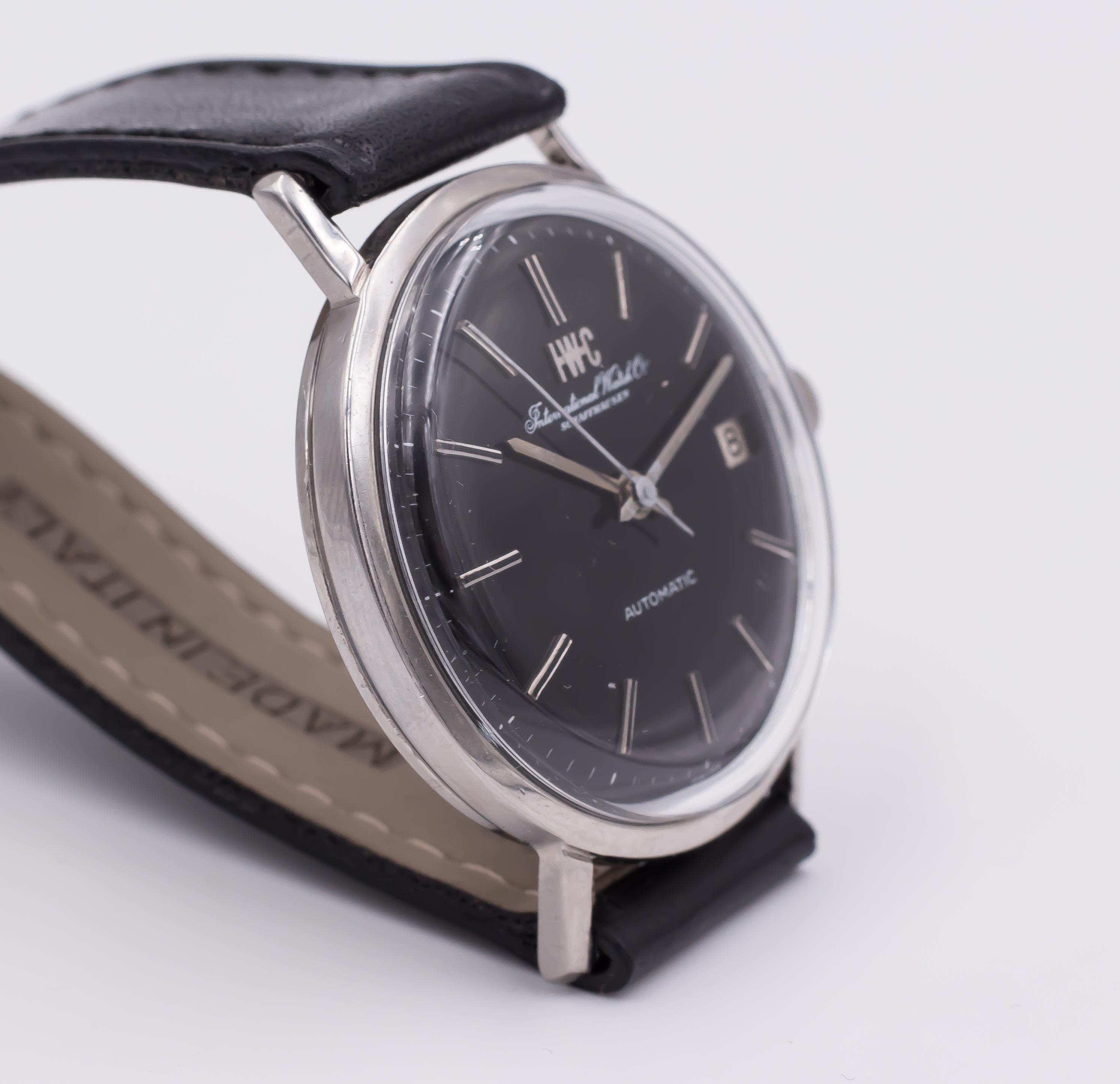 A vintage steel IWC International Watch Company automatic wrist watch with date, dating from the 1960s. 
This wrist watch is set with a very particular black dial. 

Reference: 1818
Movement: C.8541B

BRAND
IWC Internation Watch