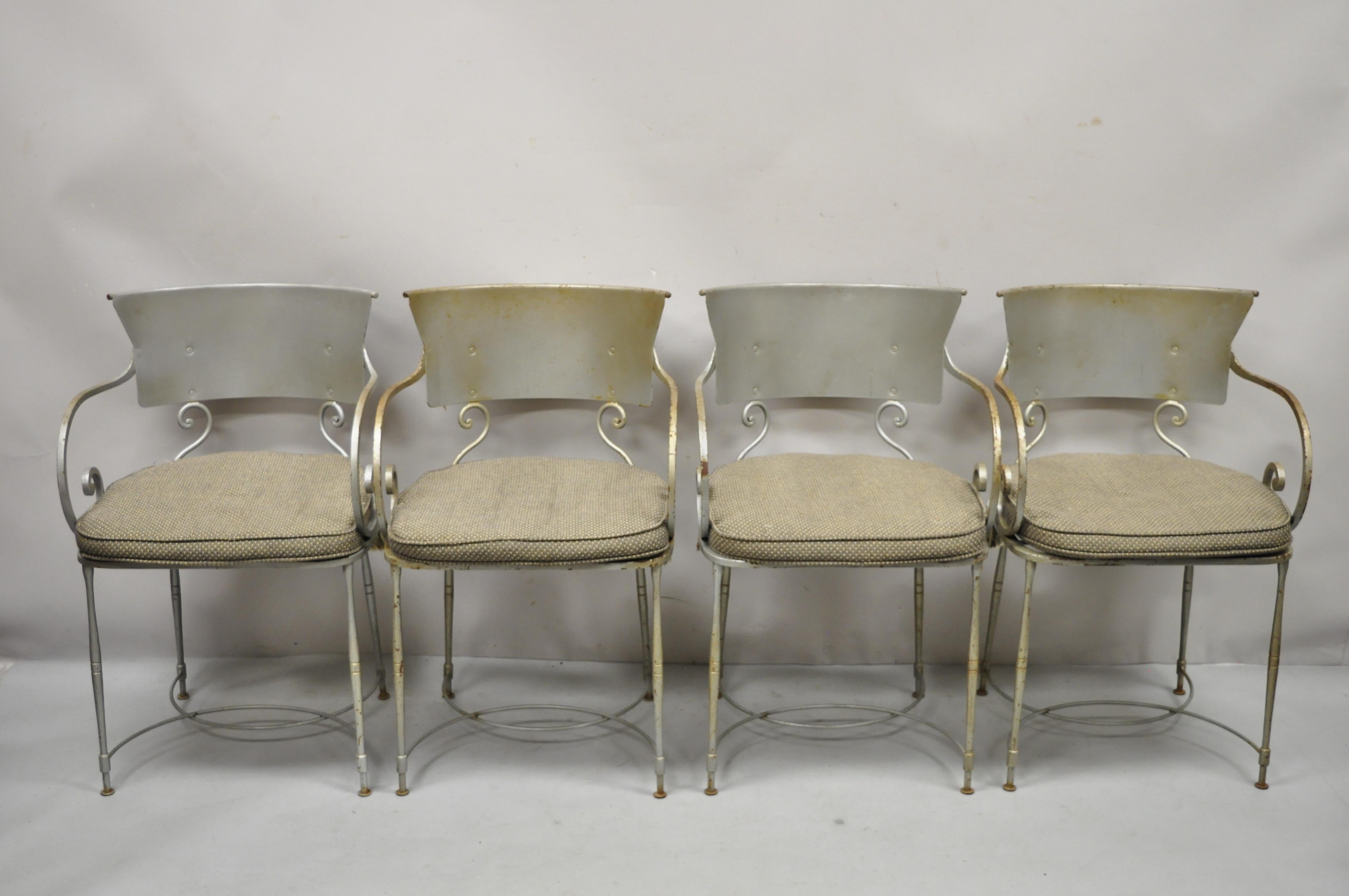 Vintage steel metal Hollywood Regency scrolling arm dining chairs - Set of 4. Set includes (4) armchairs, loose cushions, heavy steel metal frame, curved backs, stretcher base, scrolling arms, very nice vintage item, quality craftsmanship, great
