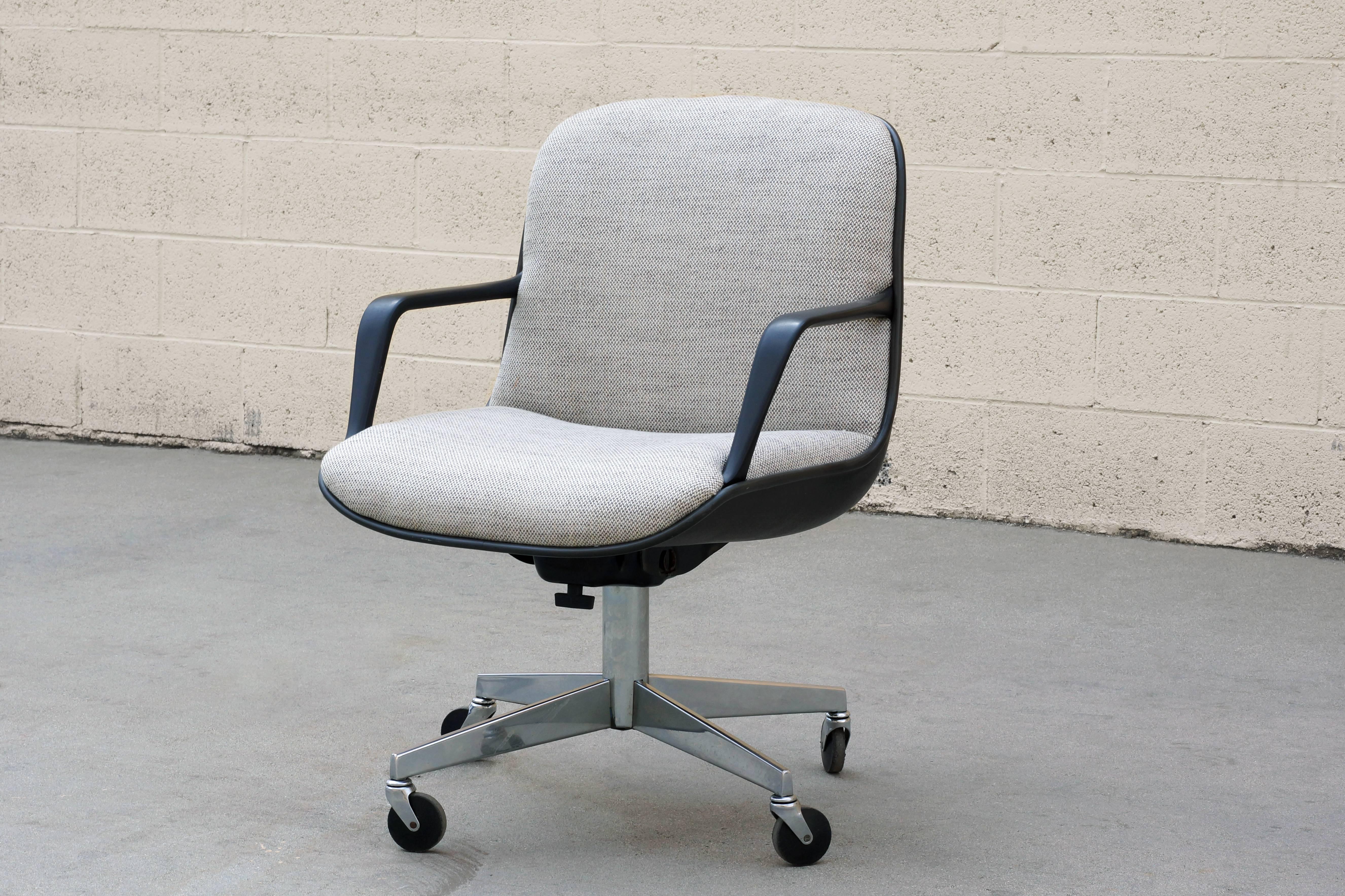 Vintage 1984 Steelcase office chair, model 451. This midcentury inspired chair features an iconic bucket seat on a chrome base. Newly reupholstered in gray tweed fabric. Rolls on casters. In the style of the famed Charles Pollock chair.