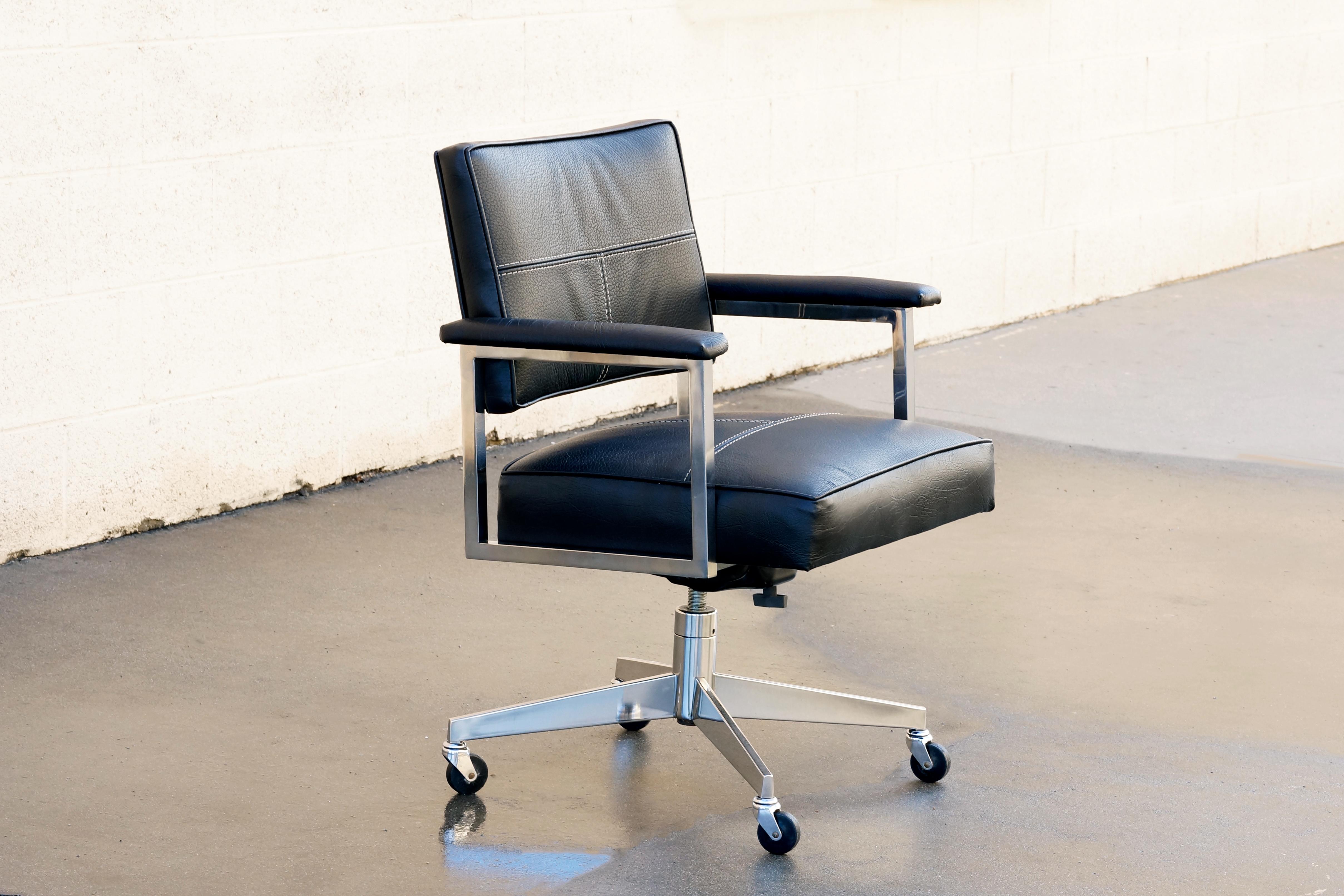 Classic tanker-style office chair by Steelcase. Newly refinished in a combination of black leather and pebbled vinyl with contrast stitching for a bold, sporty look. Swivels, rolls and adjusts. 

Dimensions: 20