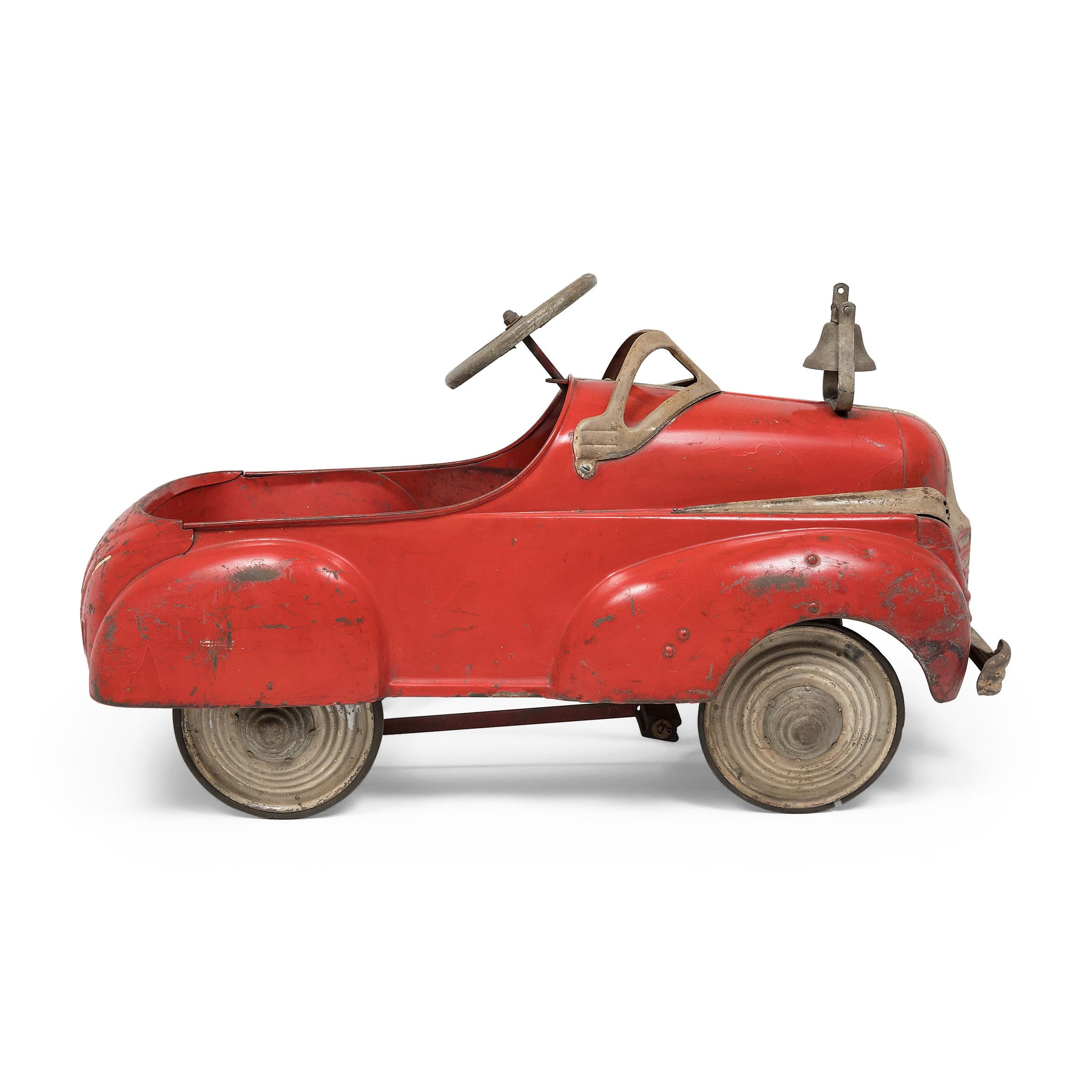Vibrant, sleek and full of character, this vintage pedal car was once the prized possession of children all across America. A popular toy since the late 19th century, pedal cars experienced a massive boom in the postwar era, becoming a staple