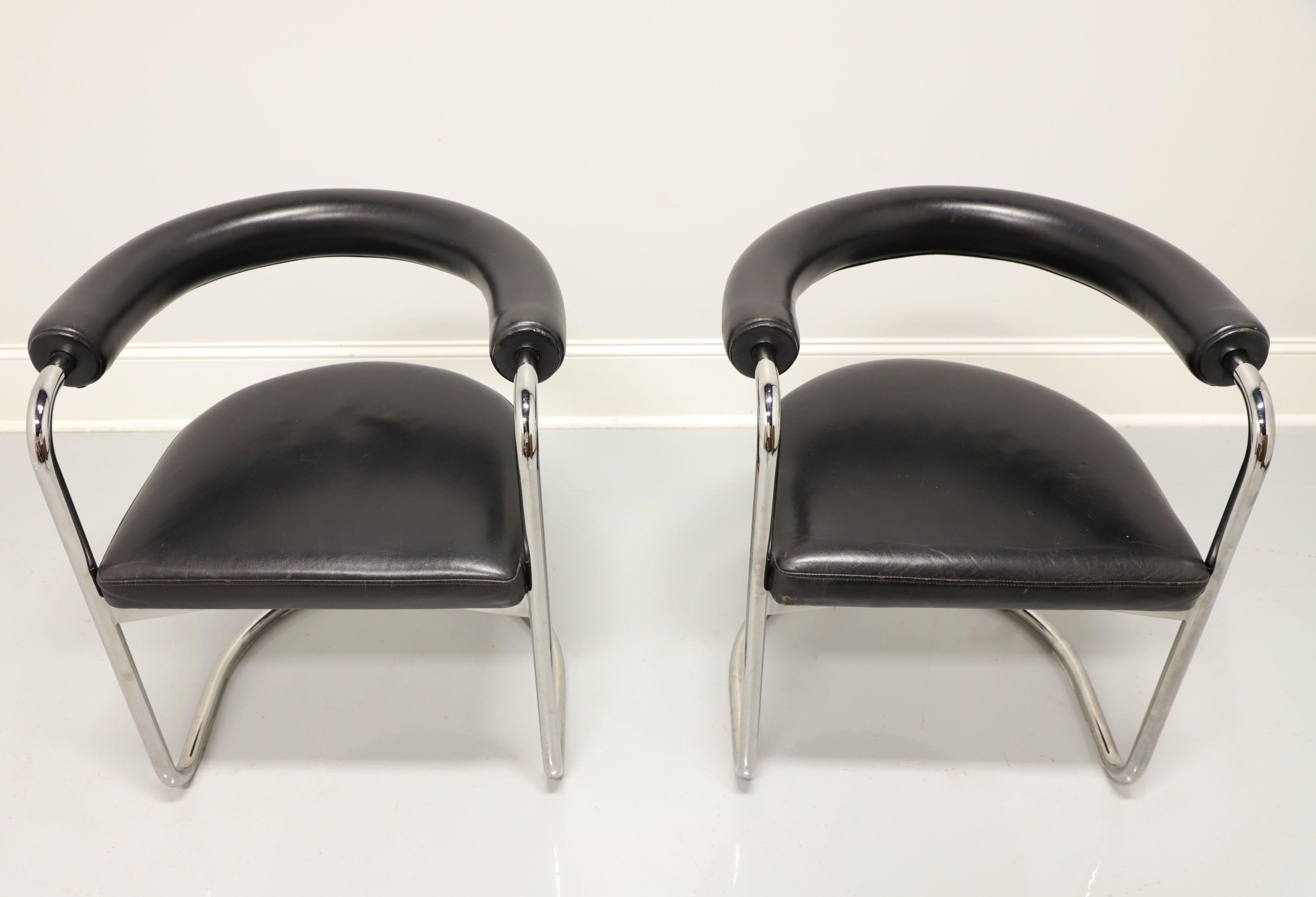 A pair of vintage Contemporary style cantilever chairs by Stendig, of New York, USA. Tubular steel frame, barrel back design, rolled upholstered black leather backs forming into the arms and black leather upholstered seats. Made in the late 20th