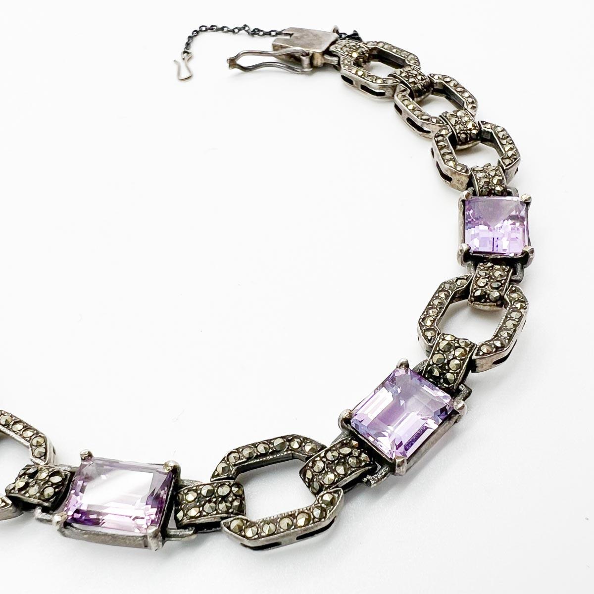 A demure and elegant Vintage Amethyst Marcasite Bracelet. Crafted in sterling silver and set with  marcasites and amethyst pastes that capture the light to perfection. A wonderful piece of original 1930s jewellery that will never cease to