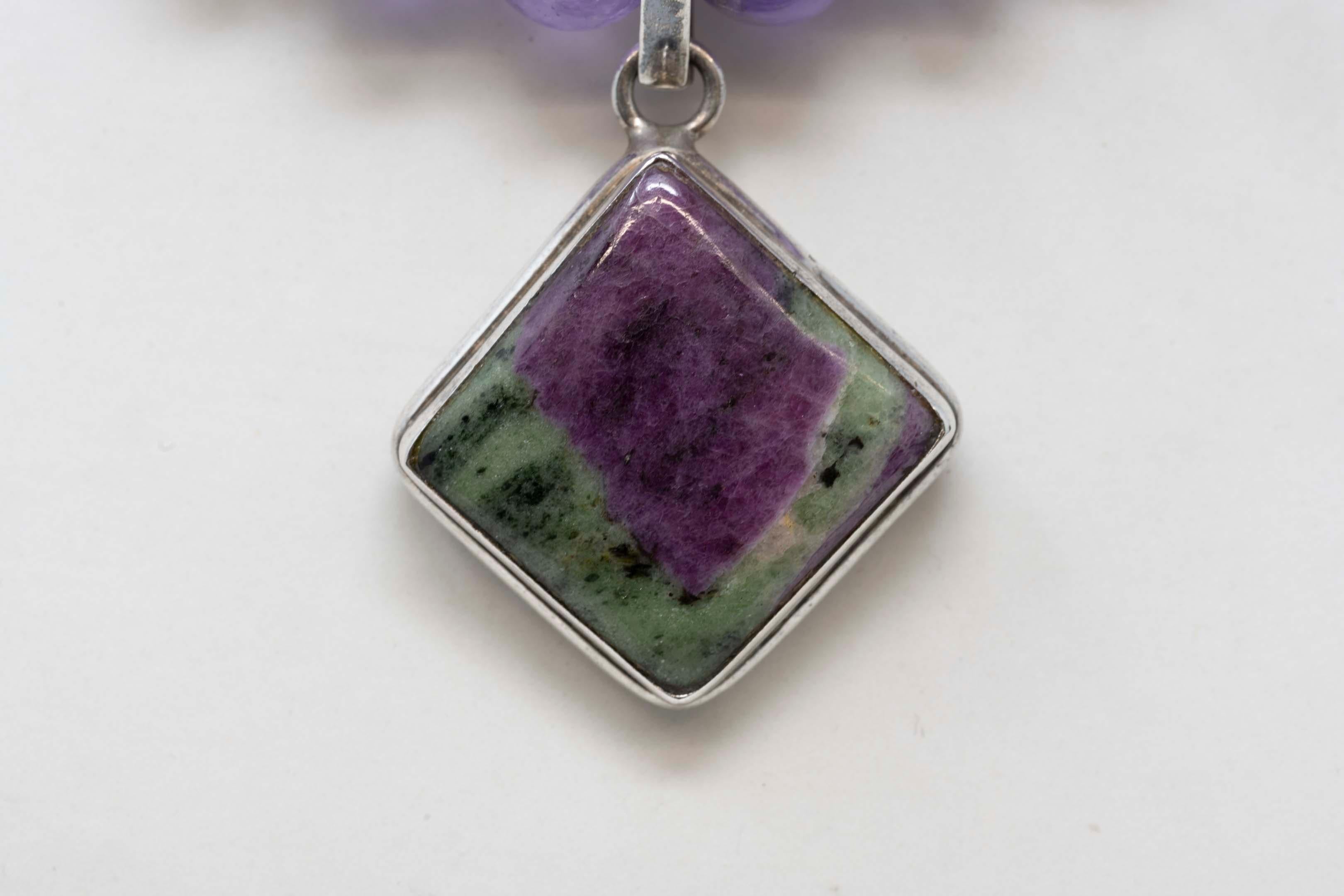 Vintage sterling silver amethyst 10mm beads and silver pendant with ruby-zoisite. Genuine stone from Tanzania, measures 18 inches long. Pendant measures 1 1/4 inches x 1 1/4 inches, stamped 925. 
