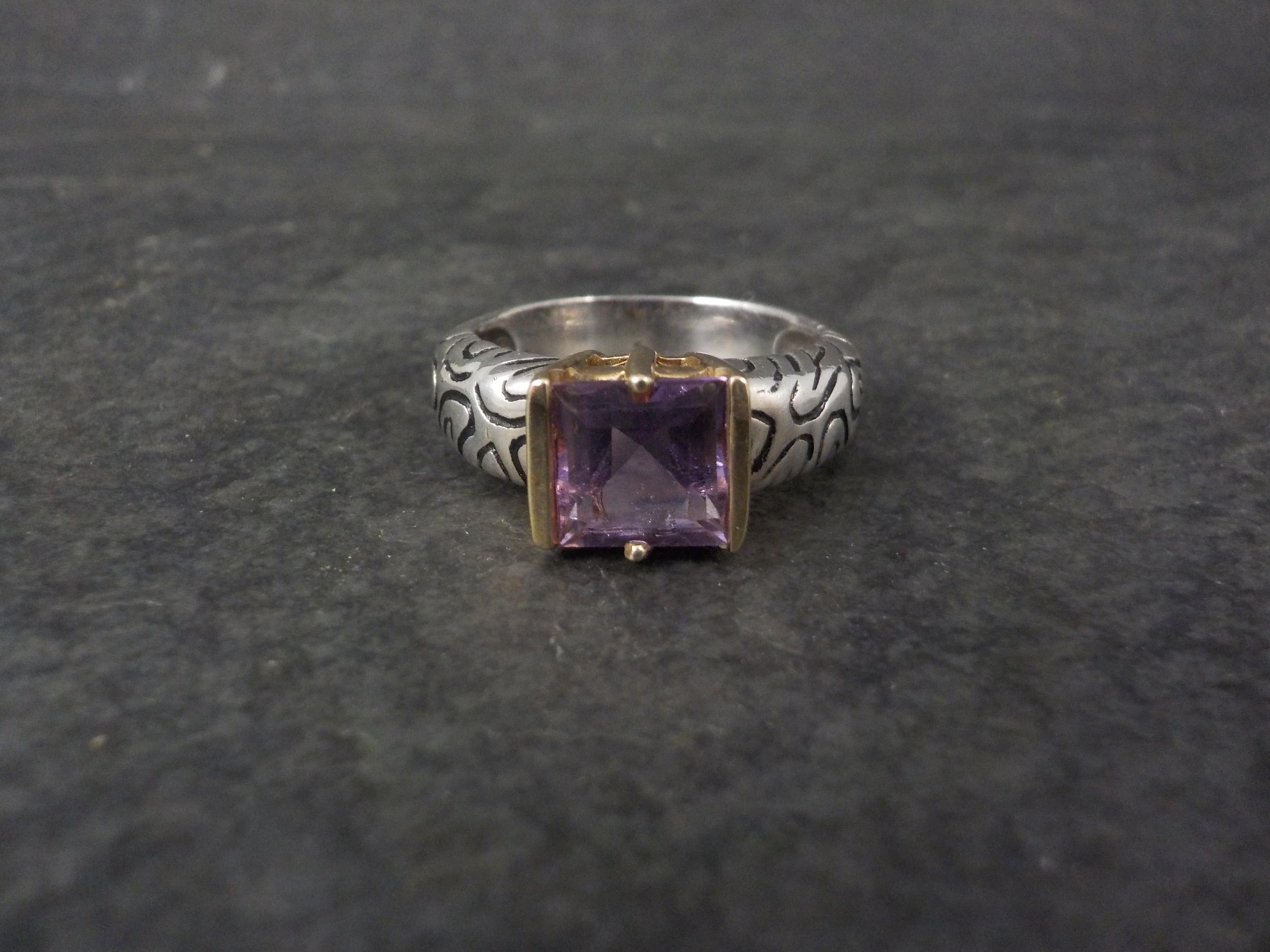 This gorgeous amethyst ring is 14K yellow gold and sterling silver.
It is the creation of the designer Clyde Duneier.

This ring features a 7x7 princess cut amethyst.

The face of this ring measures 5/16 of an inch north to south with a rise of