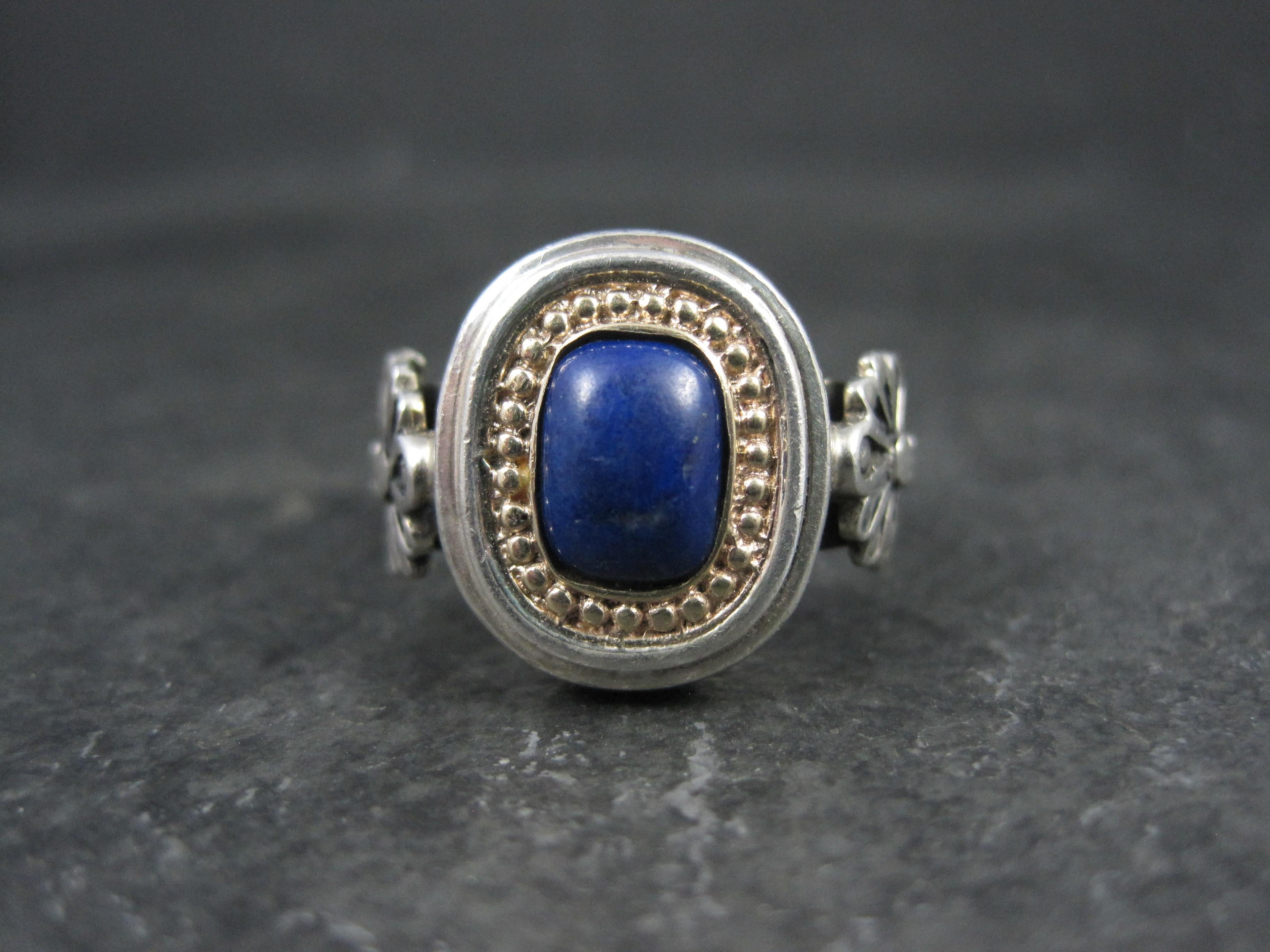 This beautiful, vintage ring is sterling silver with a 14k yellow gold bezel. It features a genuine lapis lazuli gemstone. 

The face of this ring measures 5/8 of an inch north to south with a rise of 6mm off the finger.

Size: 8

Marks: OA, 14K,