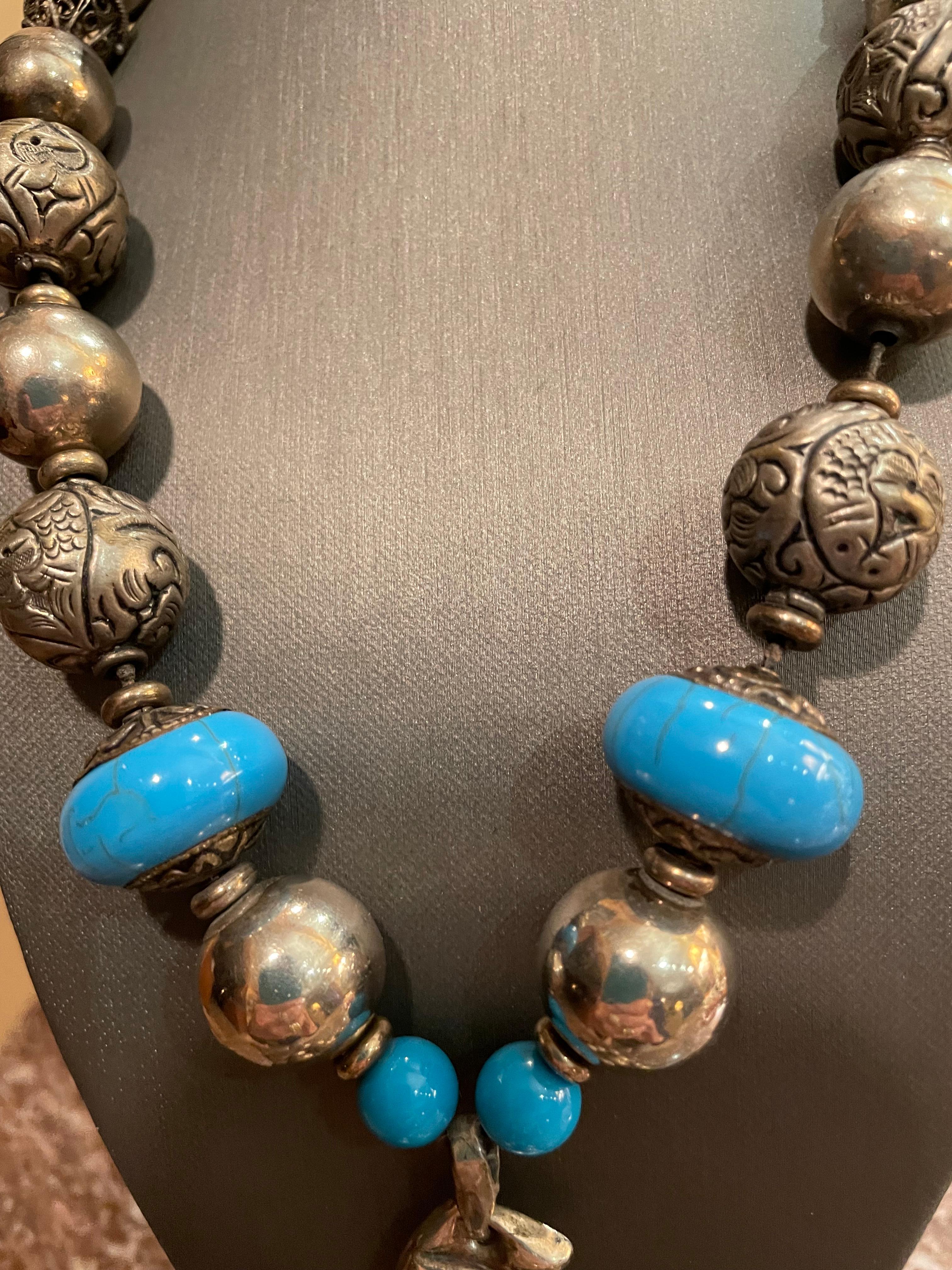 Vintage Sterling silver grapes pendant is centerpiece of handmade, one of a kind necklace from Lorraine’s Bijoux. This centerpiece hangs on a luscious string of Sterling  silver Mexican beads and silver Tibetan/turquoise engraved beads. Antique
