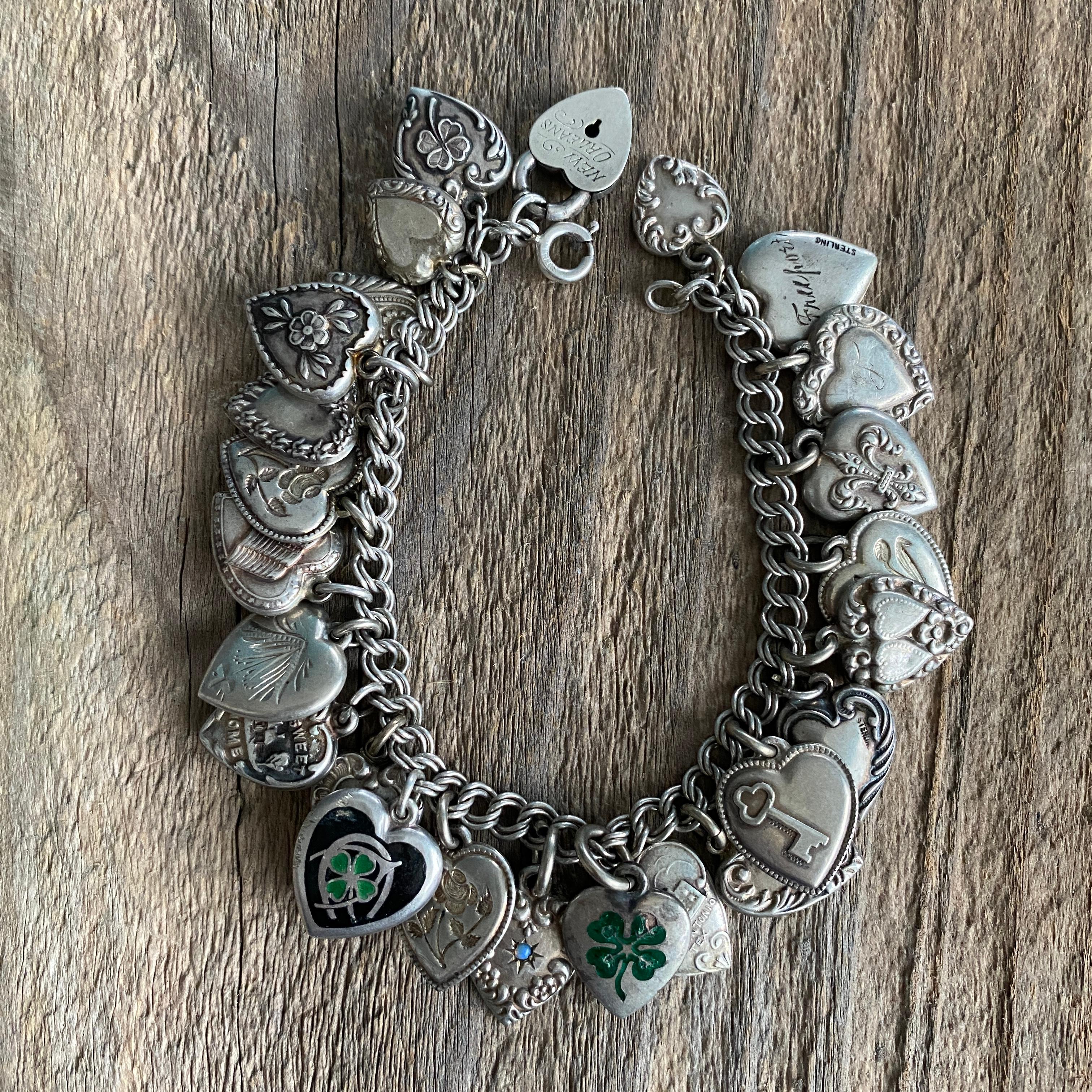 Details:
Fantastic 1940's vintage charm bracelet with puffy heart charms. This bracelet has three sweet charms with a four leaf clover theme. Super cute, good luck bracelet. Great collection of mostly two sided puffy hearts, one with a design, and