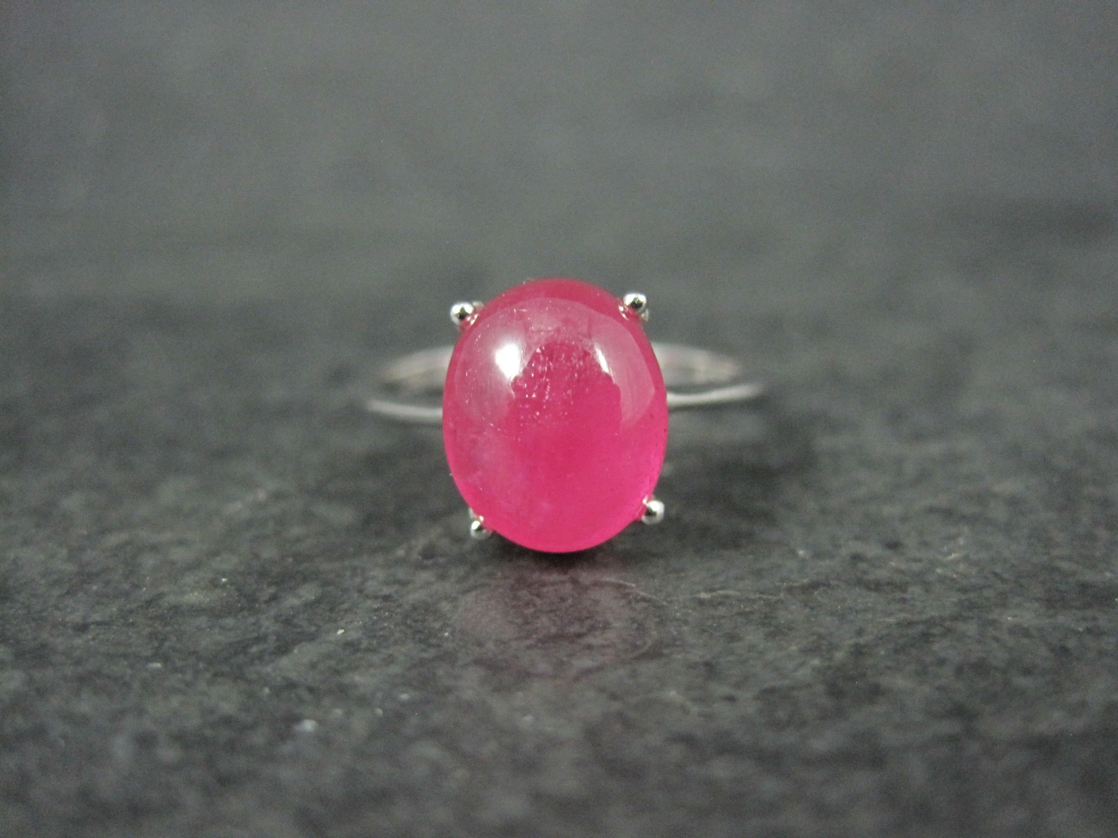This gorgeous estate ring is sterling silver.
It features a 9x11mm cabochon cut ruby.

The face of this ring measures 7/16 of an inch north to south with a rise of 9mm off the finger.
Size: 9
Marks: 925

Condition: Excellent