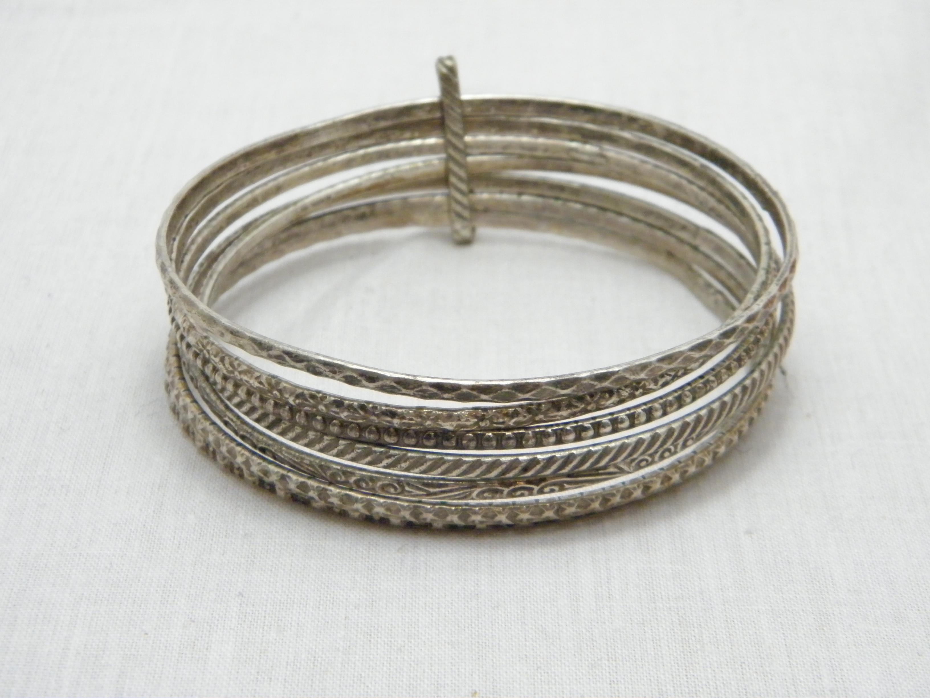 If you have landed on this page then you have an eye for beauty.

On offer is this gorgeous
STERLING SILVER UNUSUAL 7 TIERED MULTI SLAVE BANGLE BRACELET

DETAILS
Material: Thick and Heavy Sterling Silver
Style: 7 Tribal engraved slave bangles held