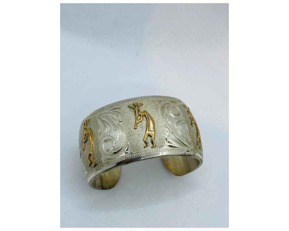 Vintage Sterling Silver 925 and 10K Gold Kokopelli Dancers Bangle Cuff 
Very Large and heavy approximately weight is 76 grams 
size is approximately 1 ½ inches wide 
SIGNED OJ 
Condition in over all excellent Condition ready to wear 
Consistent with