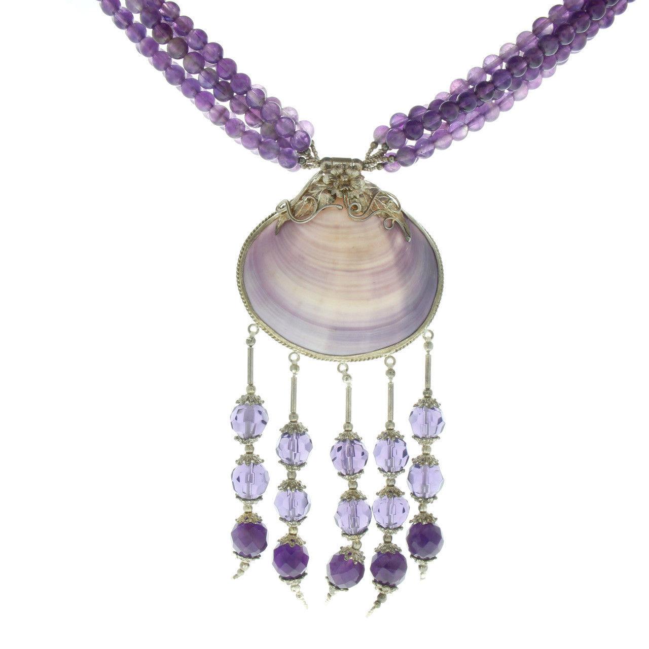  Perfect for summer or that evening beach rendezvous :)  Chic boho summer necklace that has 5 strands of genuine round Amethyst beads a shell that has been hand decorated in sterling silver and tassel accents that have multi colored faceted glass