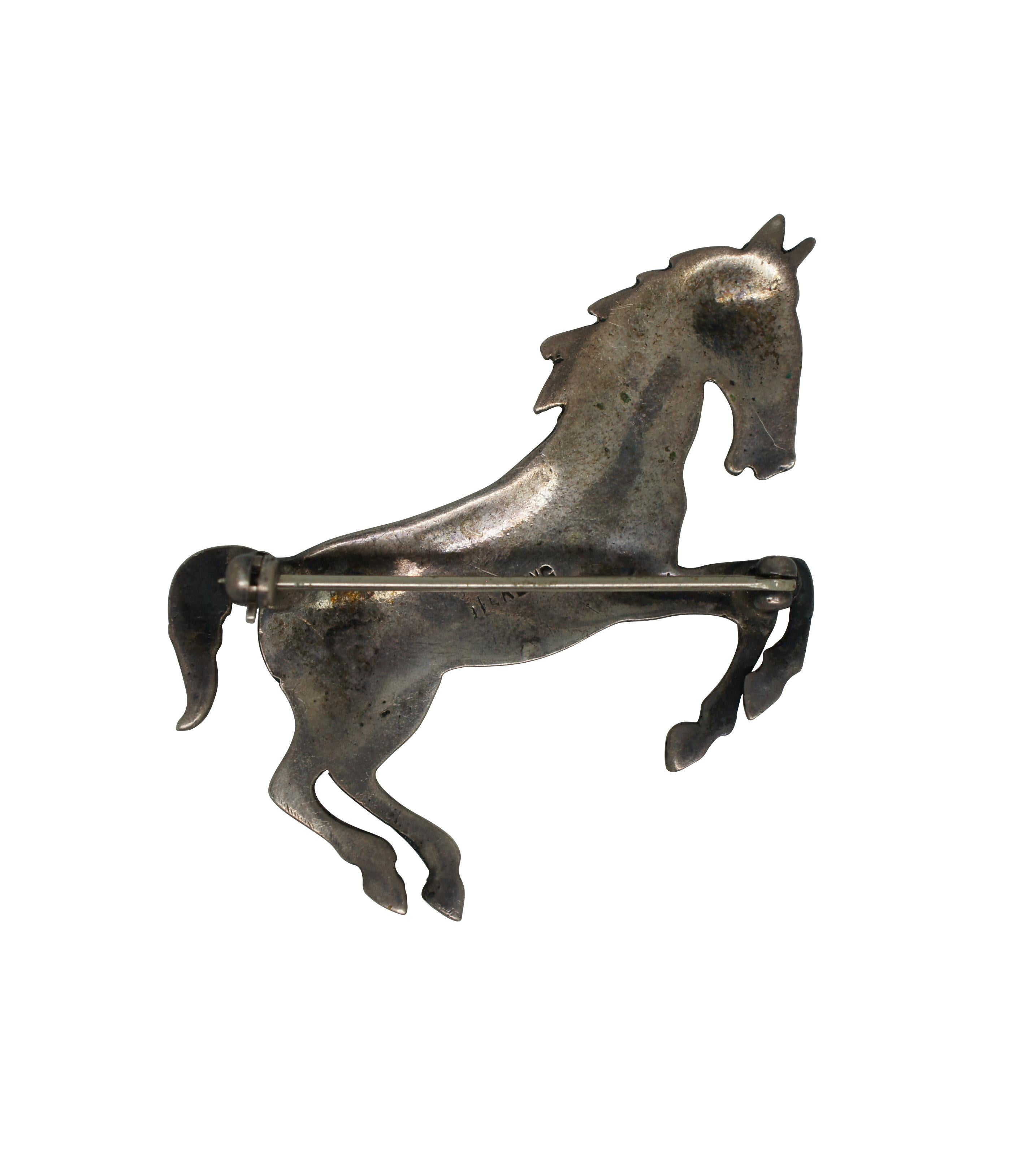 Vintage sterling silver pin / brooch in the shape of a rearing or galloping horse. Marked Sterling on verso with straight pin back.

Dimensions:
2” x 0.125” x 1.25” (Width x Depth x Height) / 8.3 g