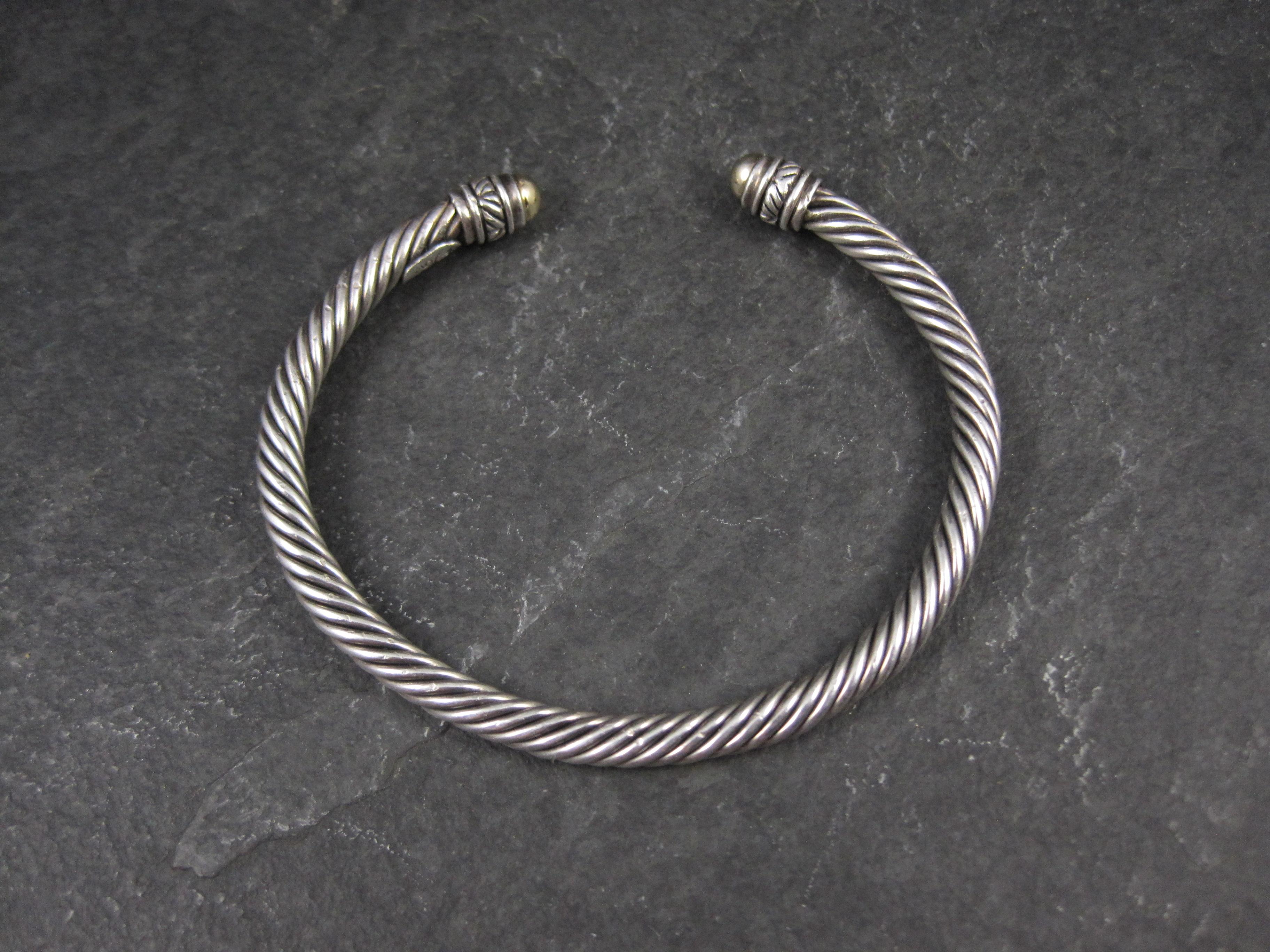 This gorgeous vintage cable cuff bracelet is a product from designer Jeffrey Levin.
It is sterling silver with 18k yellow gold tips.
It measures 5mm wide and is adjustable from 7 to 9 inches.
Weight: 18.7 grams
Condition: Excellent