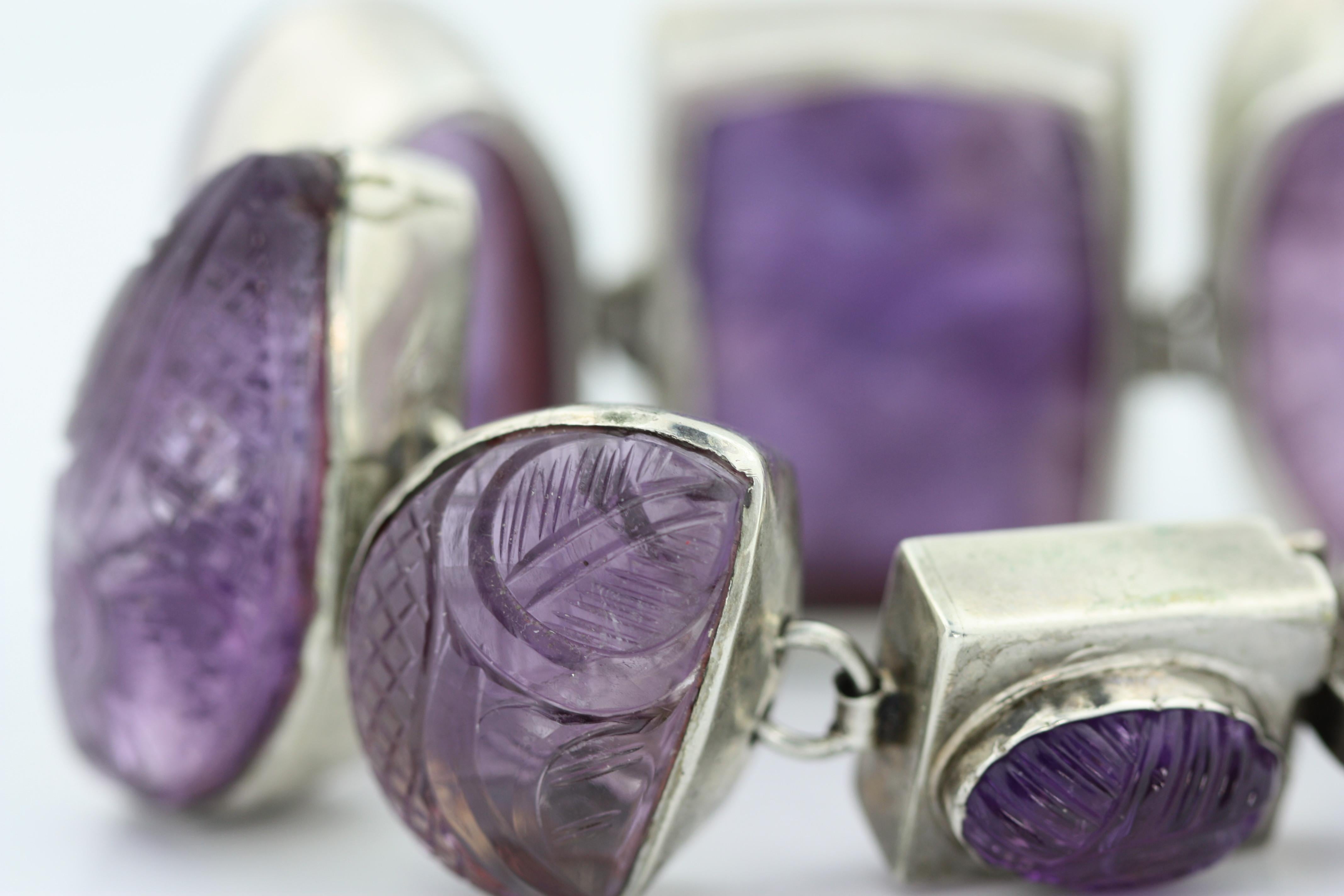 
Vintage Sterling Silver and Amethyst Bracelet, 
Composed of eight large carved amethysts mounted in silver, gross weight approximately 182 grams,
length 8 inches, 