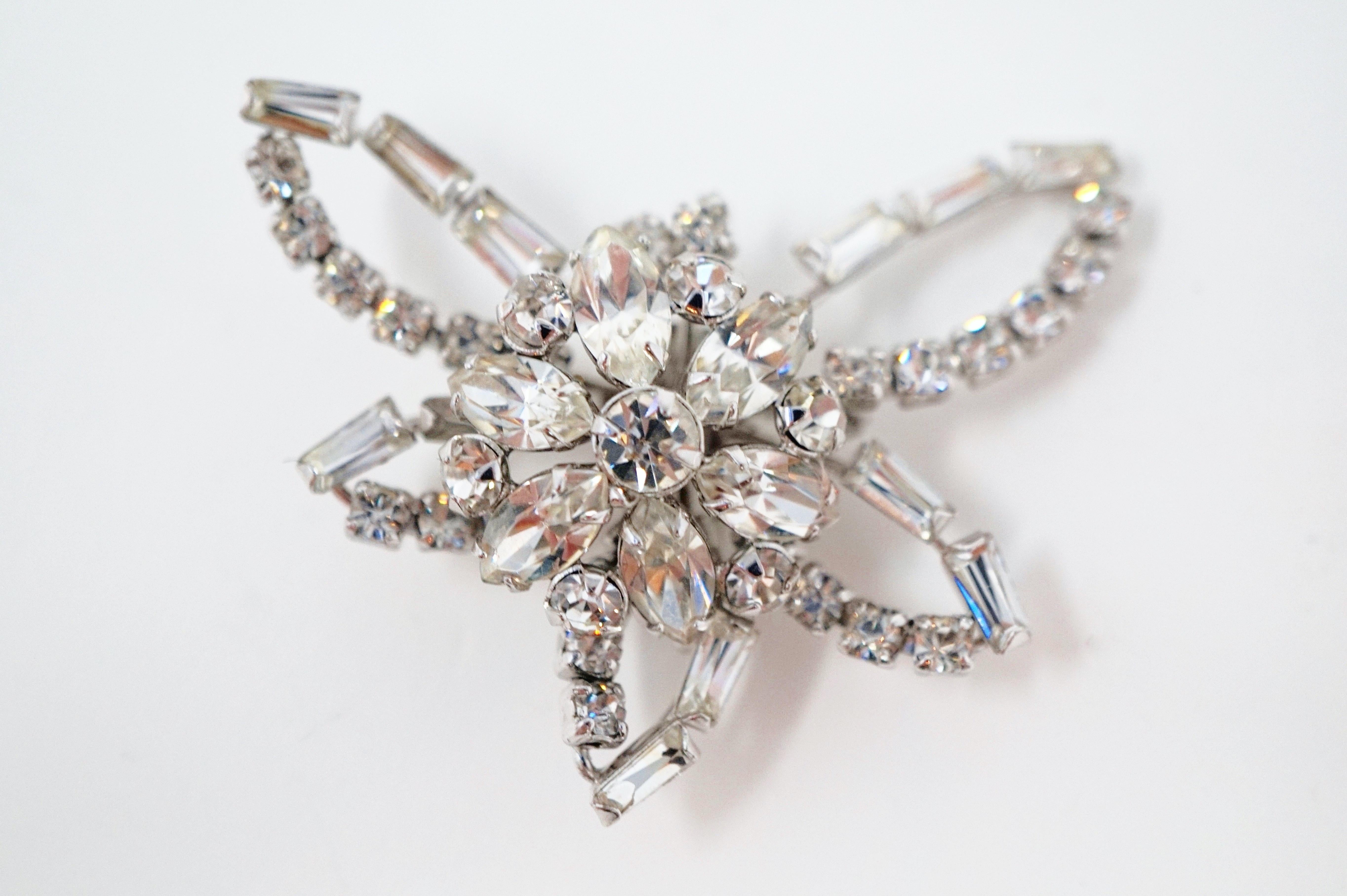 A beautiful 1950's vintage crystal rhinestone brooch with sterling silver hardware by Phyllis W. Jacobs, a popular jeweler from the mid-century. A classic accessory for wedding or formal looks. This brooch is comprised of a medley of sparkling