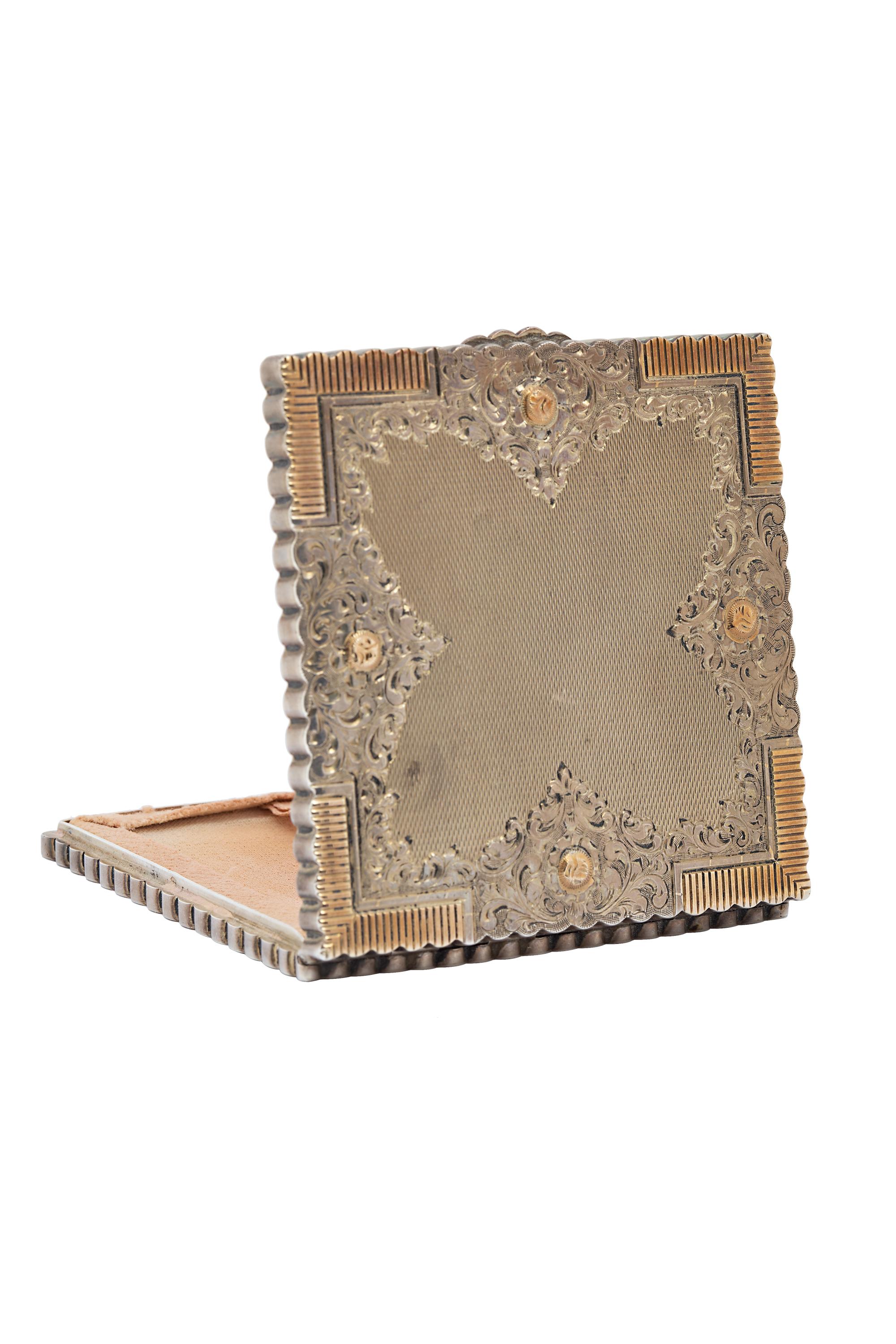 This charming and beautifully detailed vintage sterling silver and gold powder compact features intricate hand engraving to create a delightful and practical accessory. Measuring 3 x 3 inches. Weighing 133.1 grams