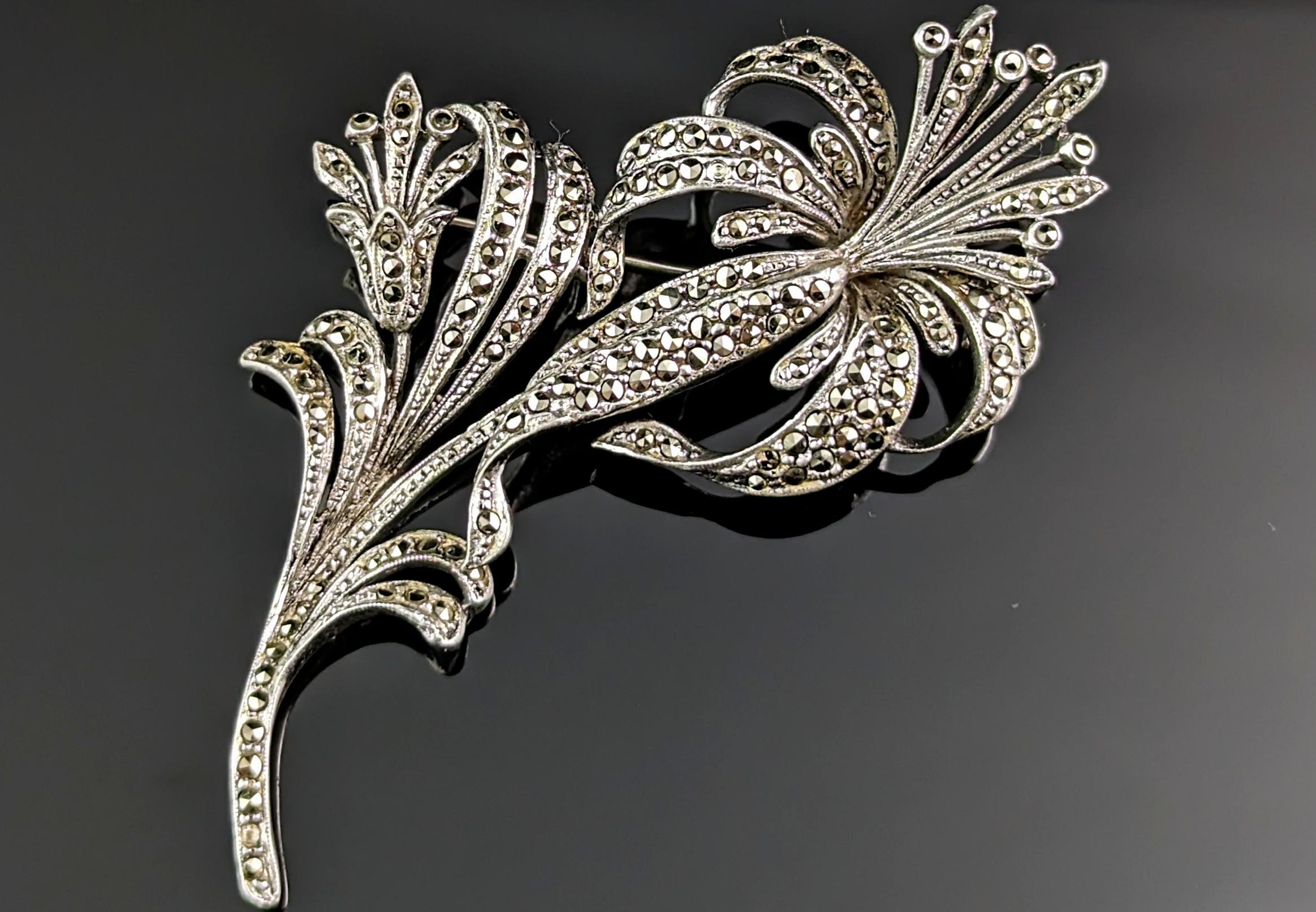 This vintage sterling silver and marcasite flower brooch is a truly beautiful piece.

It is a large sized brooch that could be worn in many ways and the marcasite gives just the right amount of sparkle and shimmer.

The brooch is designed as a large