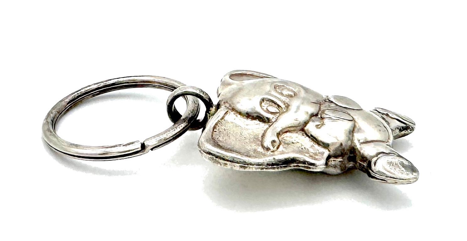 This fantastic key ring with the pendant of a sitting baby elephant was created in Italy out of sterling silver. The key ring is impressed with 925 for sterling silver and has ITALY impressed on it. The eyelet of the elephant has also ITALY