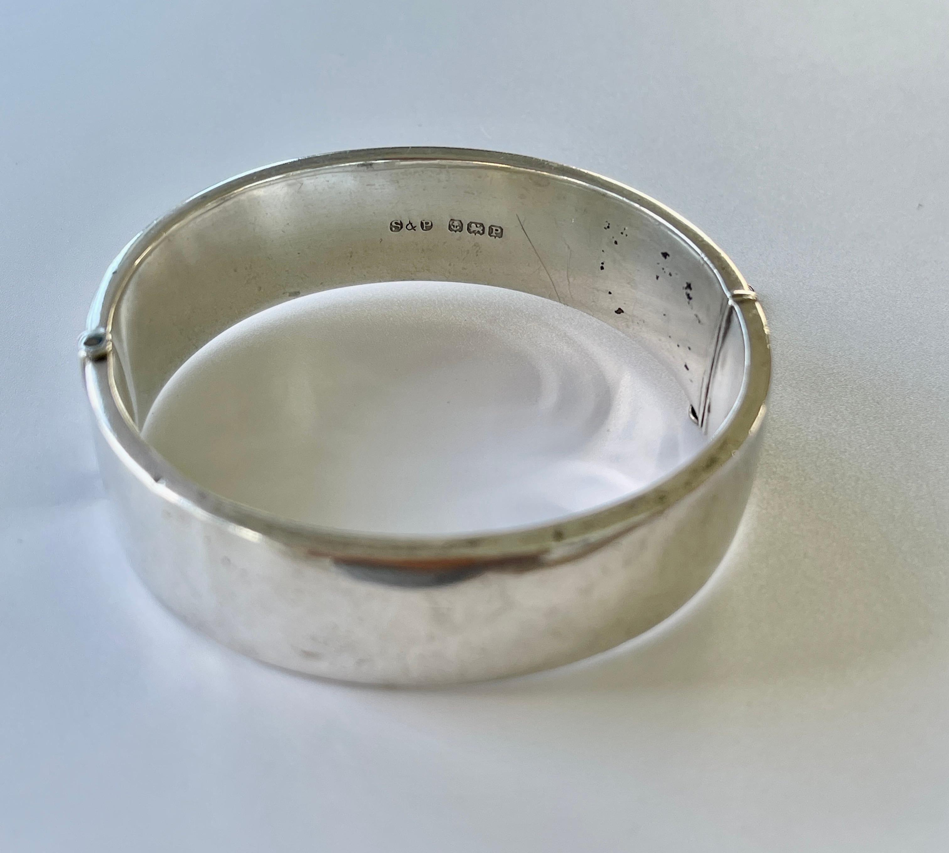 This beautiful bangle is WWII vintage era.

It is crafted in solid sterling silver and features hand engraved flower design.  It was crafted in Birmingham in 1939, the very year that WWII began.  Perhaps it was from a soldier about to leave for