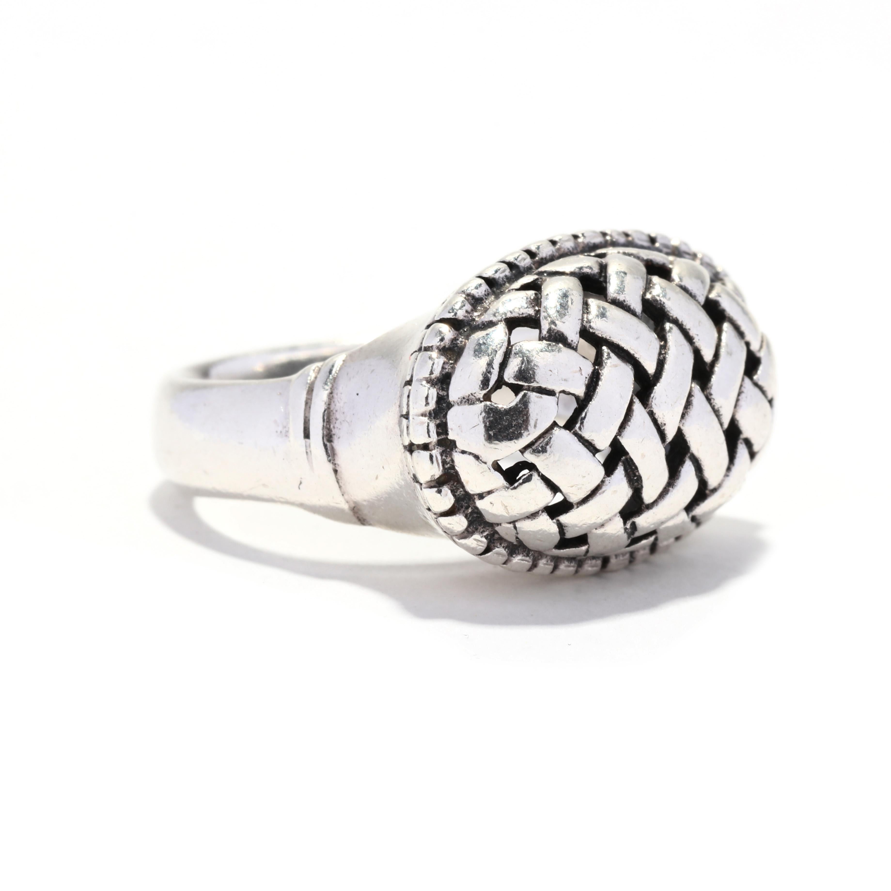 A vintage sterling silver basketweave dome ring. This ring features a large oval form with a woven, basketweave motif and a tapered band.

Ring Size 6.75

Rise Off Of Finger: 9 mm

Length: 14.7 mm

Weight: 5.6 dwts. / 8.8 grams

Stamped: 925

Ring