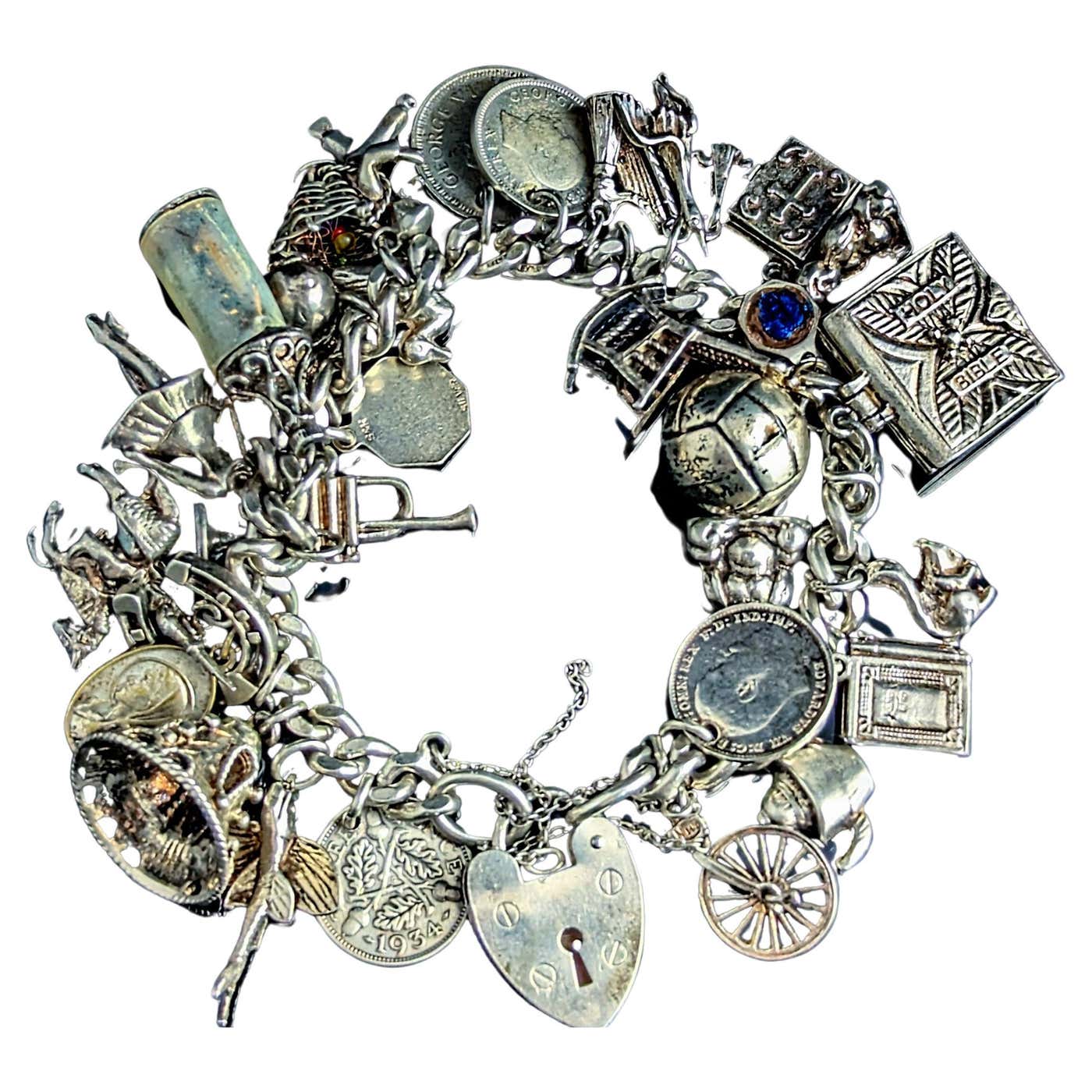 Vintage sterling silver charm bracelet, heavy, loaded For Sale at 1stDibs