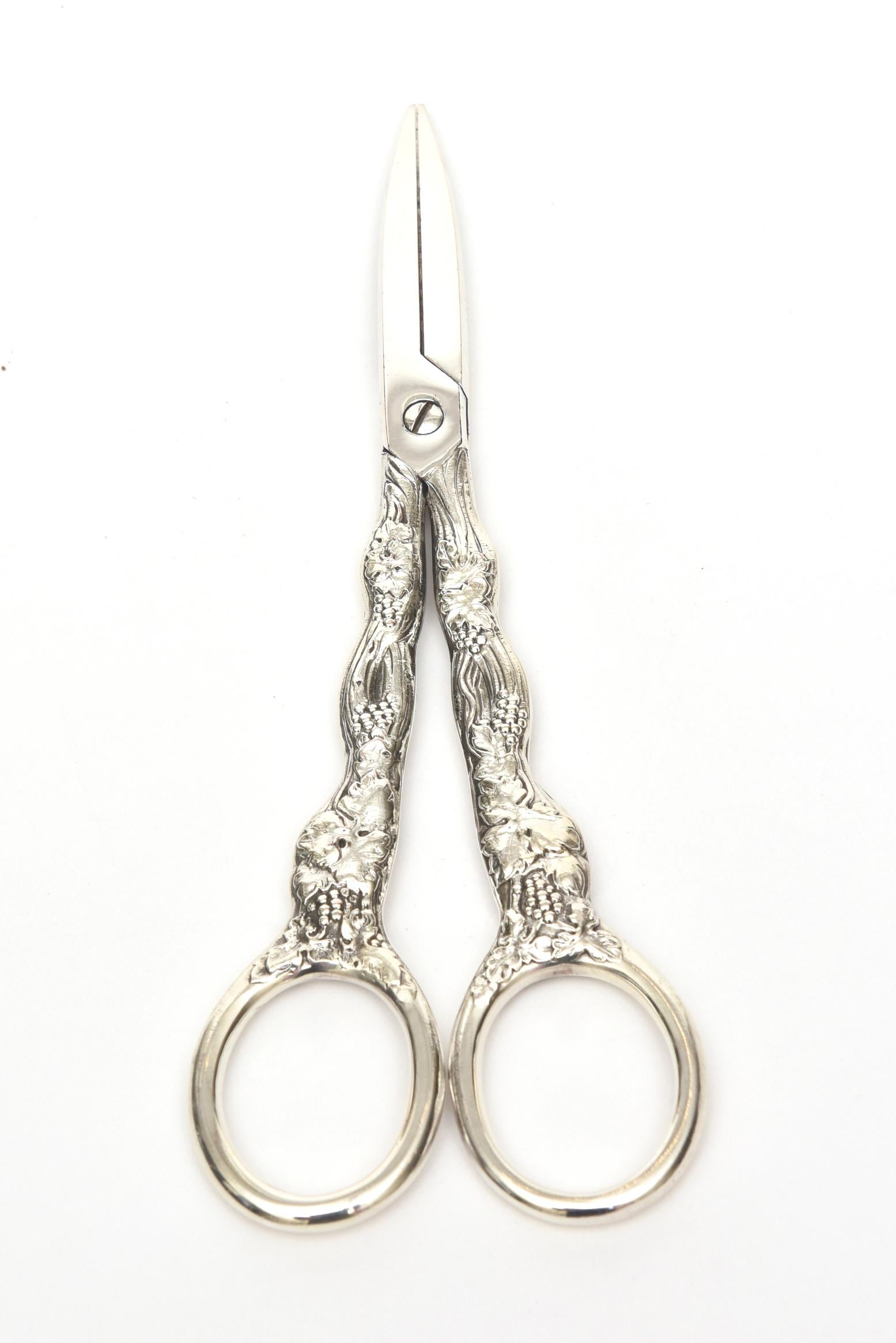 These lovely French sterling silver Christofle grape shears are marked Christofle France. They have the lovely design of chased grape and vine in raised pattern. They are Classic and timeless for serving and preparation for your grapes.
