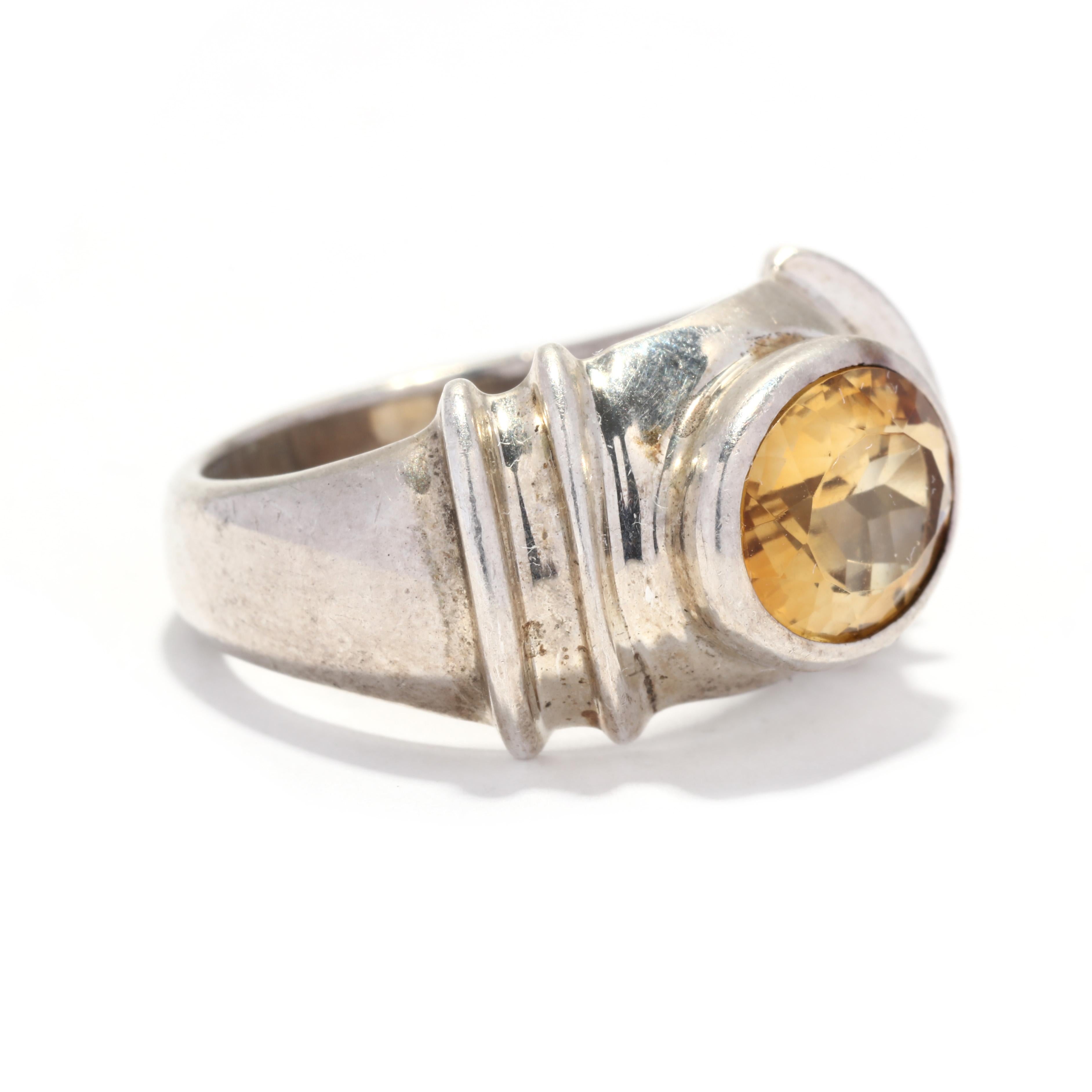 A vintage sterling silver citrine ring. This November birthstone ring features a bezel set, oval citrine weighing approximately 3.25 carats and with a ribbed, tapered band.

Stones:
- citrine, 1 stone
- oval cut
- 11 x 9 mm
- approximately 3.25