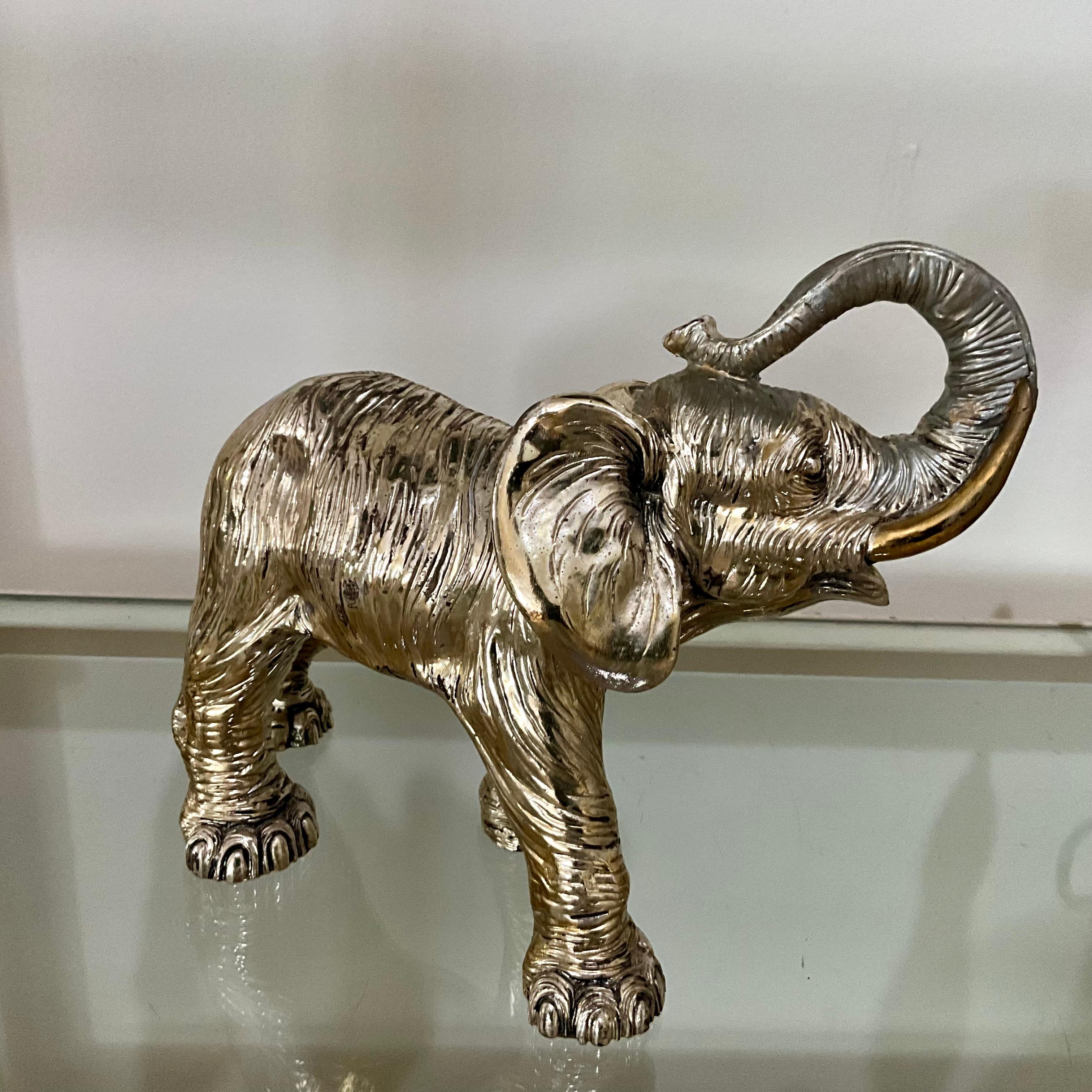 Vintage Sterling Silver Clad Elephant Sculpture with Raised Trunk, 925 Stamp & Gold Wash Tusks

A striking vintage sterling silver elephant with raised trunk — a universal symbol of luck and prosperity — accented with gold wash tusks and hallmarked