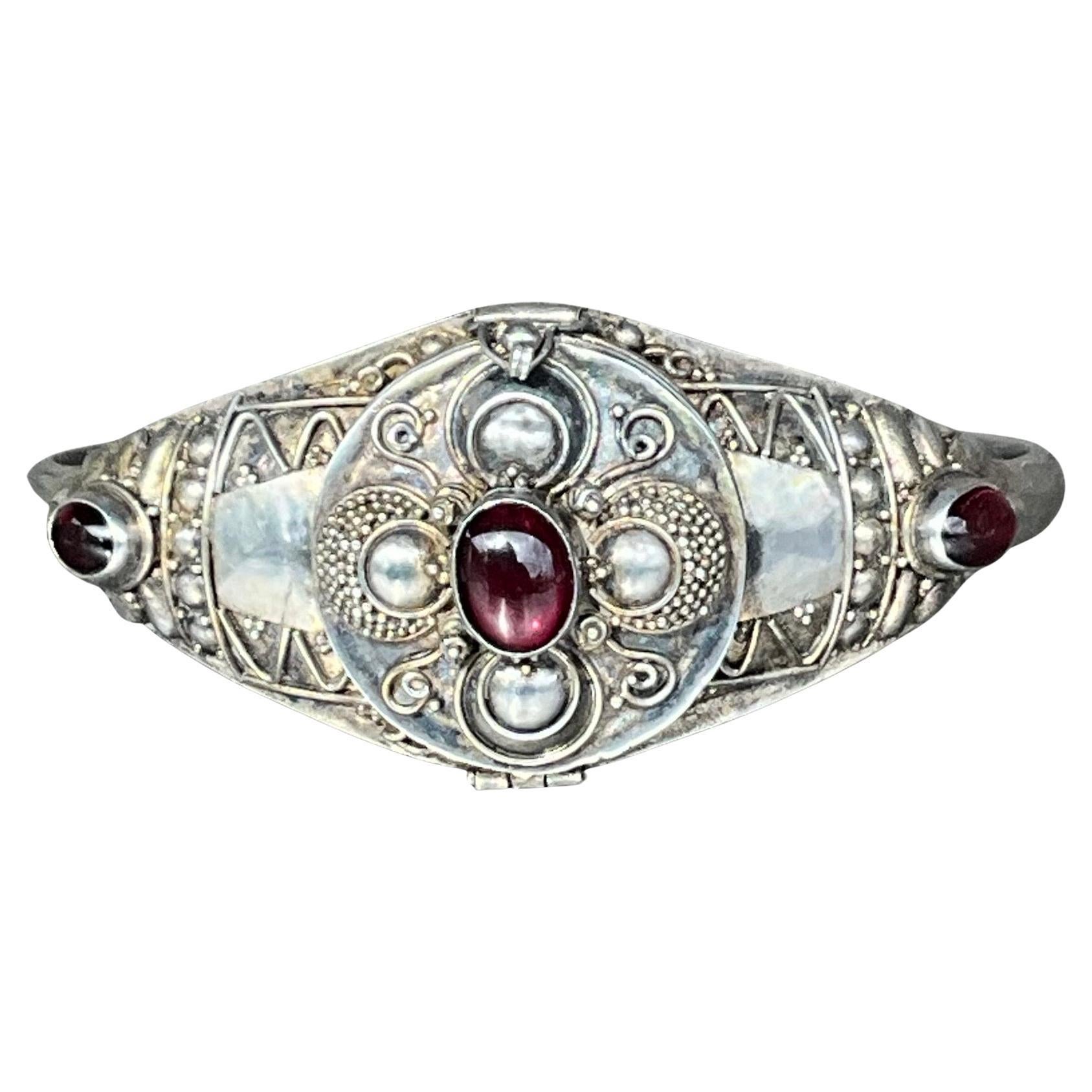 Channel timeless mystery and vintage elegance with this stunning Sterling Silver Cleopatra Poison Locket Cuff Bracelet. Inspired by the opulence of ancient Egypt and the allure of classic design, this unique piece combines history, symbolism, and