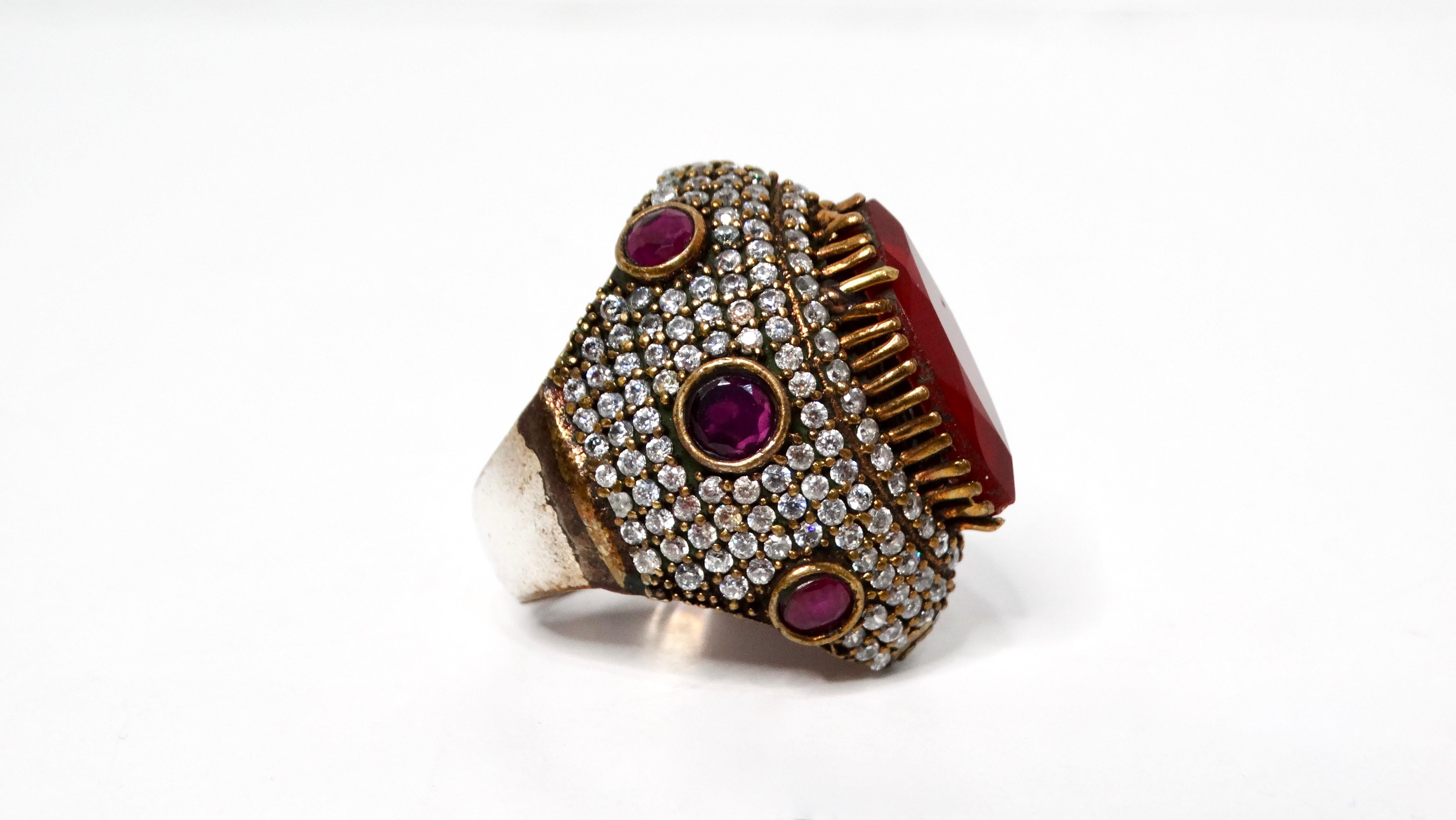 Introducing the Vintage Sterling Silver Costume Ruby & Rhinestone Statement Cocktail Ring, a dazzling piece that captures the glamour of vintage jewelry. This ring is a mixture of sterling silver and brass. This stunning ring features a vibrant