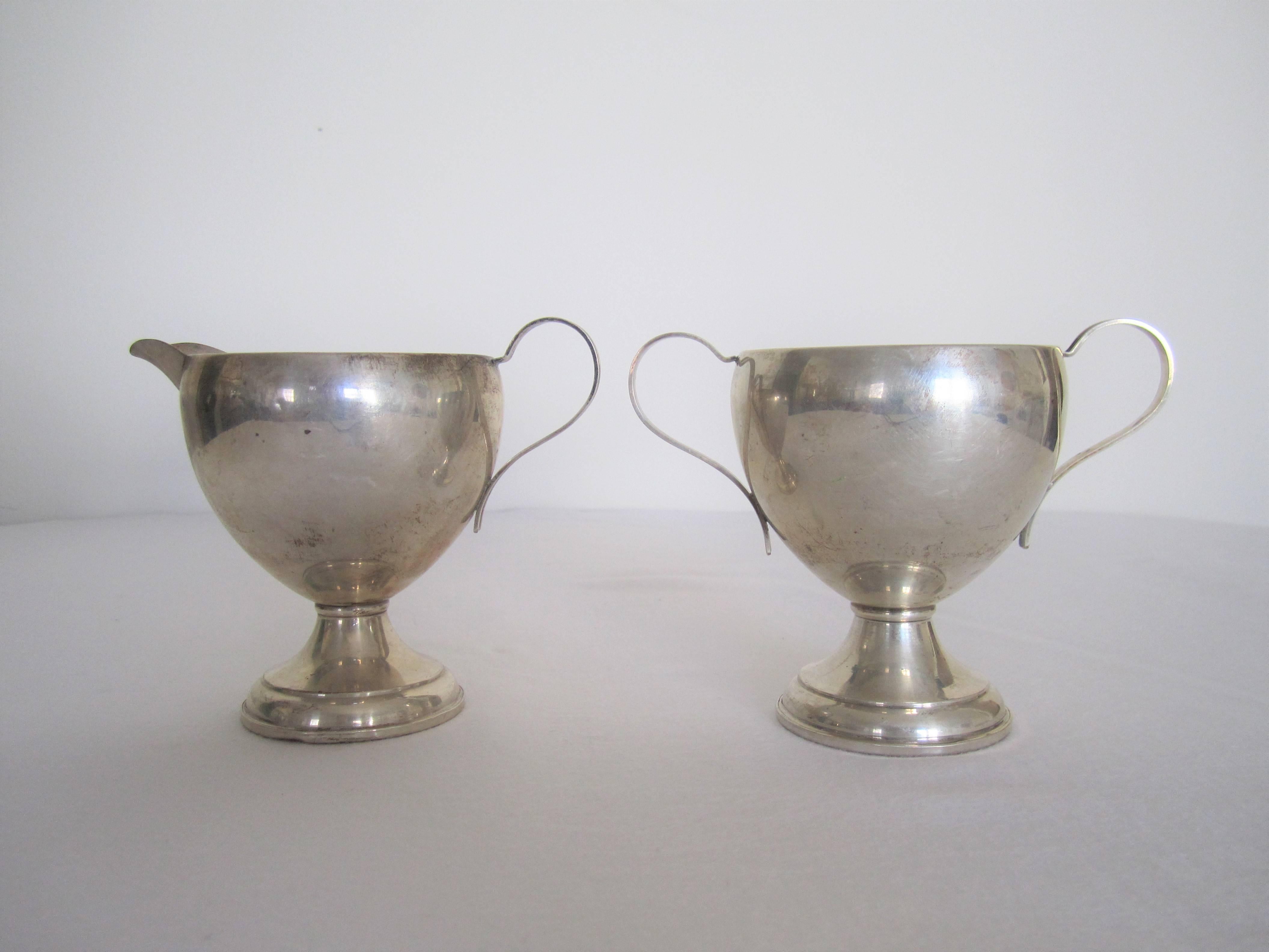 A vintage sterling silver creamer and sugar set, circa mid-20th century or earlier. With maker's mark and marked 'sterling silver' on bottom as shown in last image.

