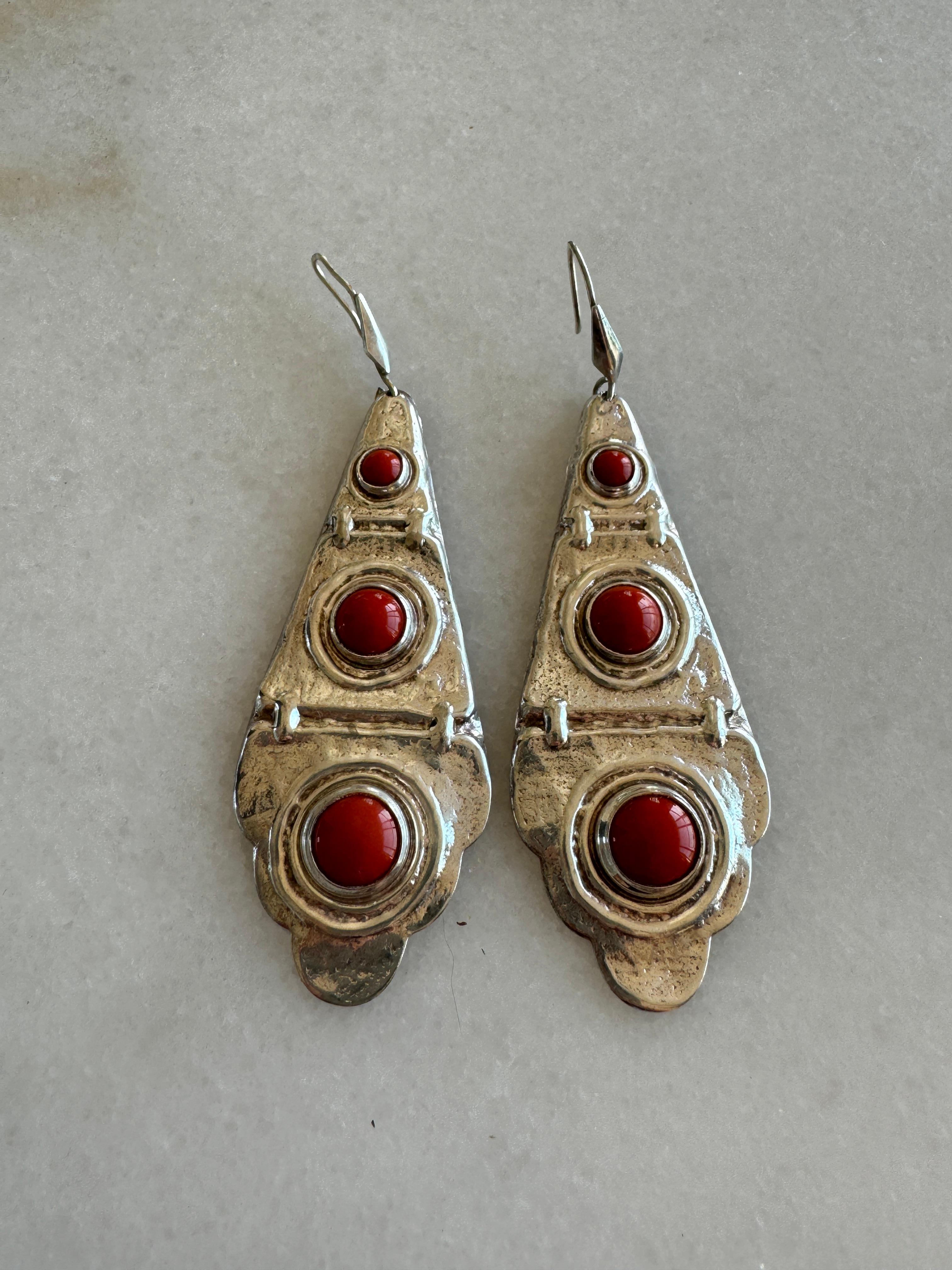 Vintage Sterling Silver Earrings with Coral Cabochon stones. These earrings are lightweight and easy to wear. Patina is consistent with age. A silver cloth can be used on the silver to enhance the luster and shine. 
