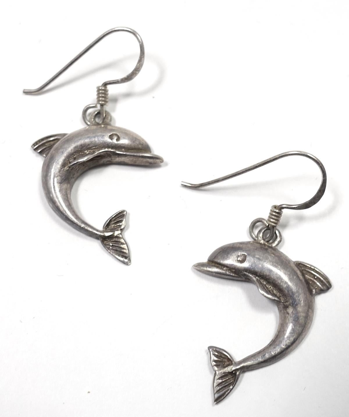 These vintage earrings feature cute dolphins in sterling silver.  These pierced earrings measure 1-1/2” x 3/4” and are in excellent condition.